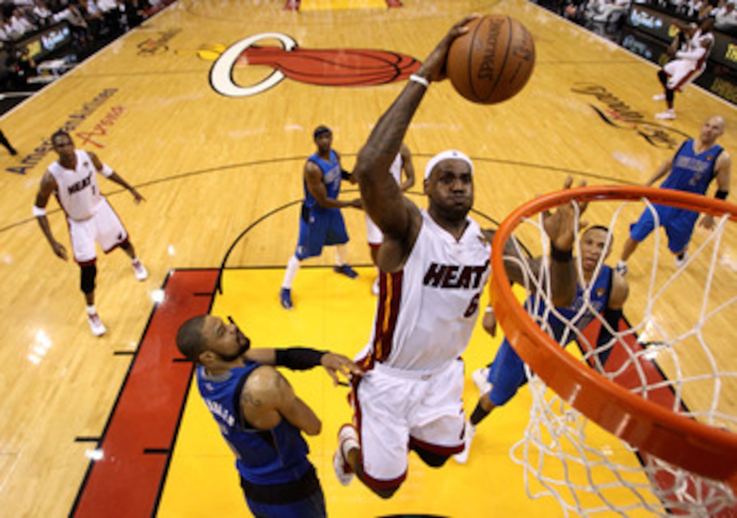 MIAMI, FL - MAY 31:  LeBron James #6 of the Miami Heat dunks the ball over Tyson Chandler #6 of the Dallas Mavericks in the fourth quarter in Game One of the 2011 NBA Finals at American Airlines Arena on May 31, 2011 in Miami, Florida. NOTE TO USER: User