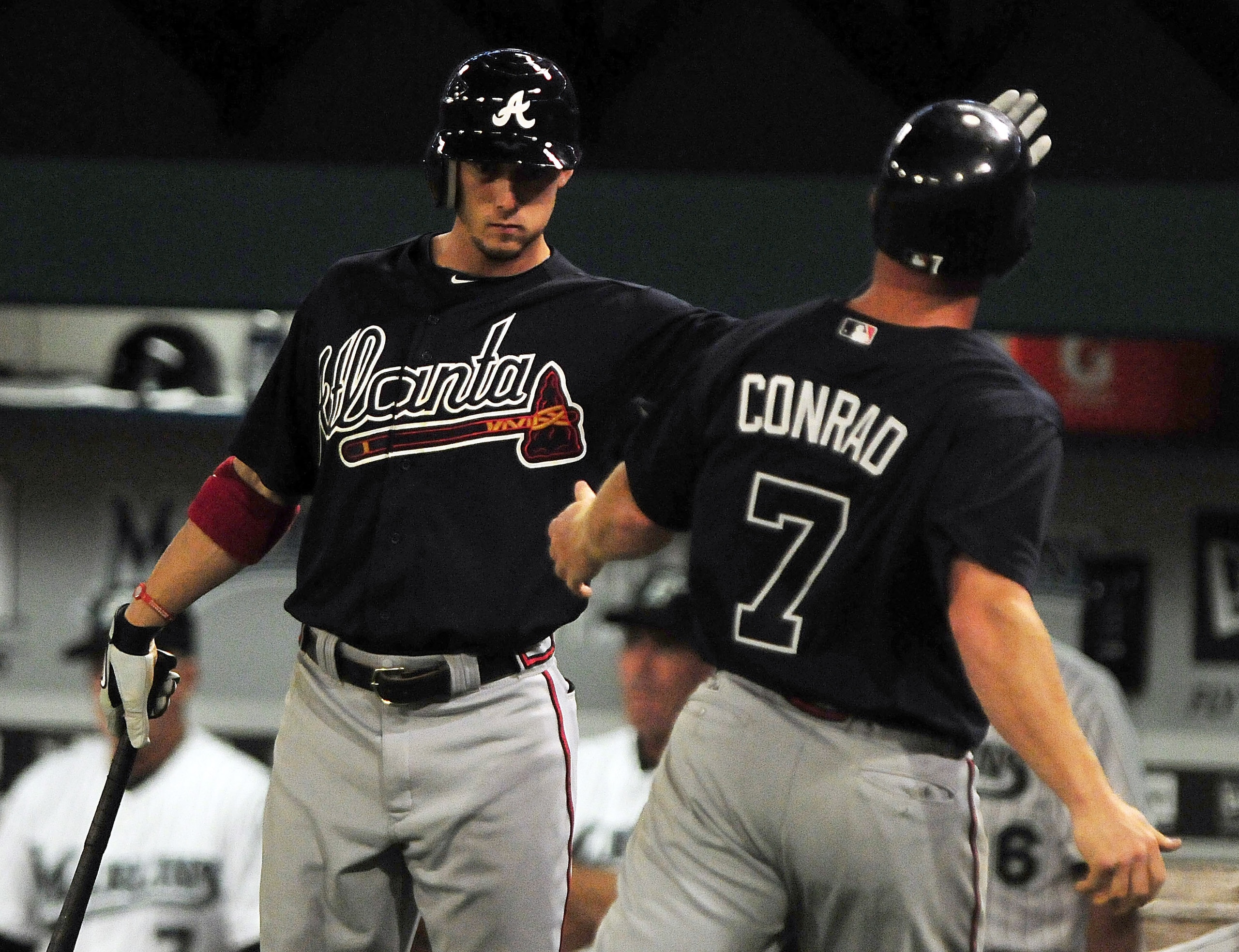 MIAMI GARDENS, FL - JUNE 09: Brooks Conrad #7 celebrates with Jordan Schafer #1 of the Atlanta Braves after scoring against the Florida Marlins at Sun Life Stadium on June 9, 2011 in Miami Gardens, Florida. (Photo by Marc Serota/Getty Images) MIAMI GARDENS, FL - JUNE 09: Brooks Conrad #7 celebrates with Jordan Schafer #1 of the Atlanta Braves after scoring against the Florida Marlins at Sun Life Stadium on June 9, 2011 in Miami Gardens, Florida. (Photo by Marc Serota/Getty Images)