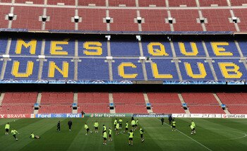BARCELONA, SPAIN - APRIL 05:  FC Barcelona players practice backdropped by the words 'More than a club' written in the stands during a training session ahead of their UEFA Champions League quarter final second leg match against Arsenal at the Camp Nou sta