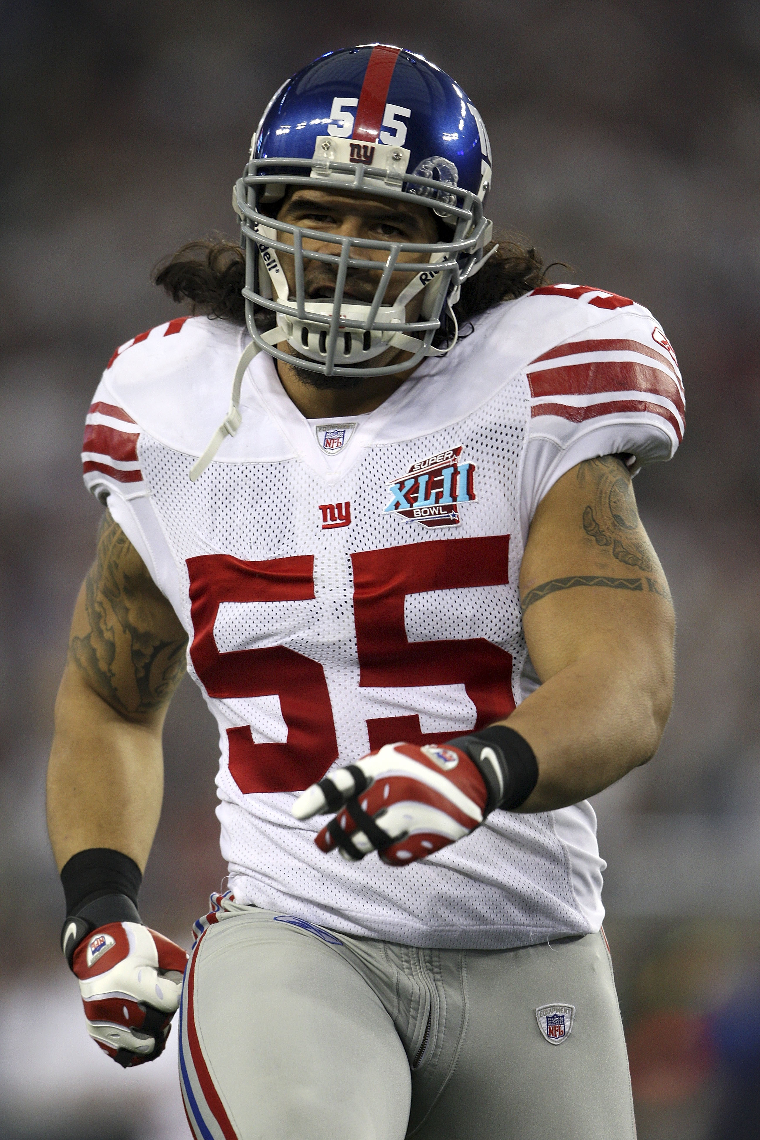 GLENDALE, AZ - FEBRUARY 03:  Kawika Mitchell #55 of the New York Giants runs onto the field against the New England Patriots during Super Bowl XLII on February 3, 2008 at the University of Phoenix Stadium in Glendale, Arizona.  (Photo by Andy Lyons/Getty