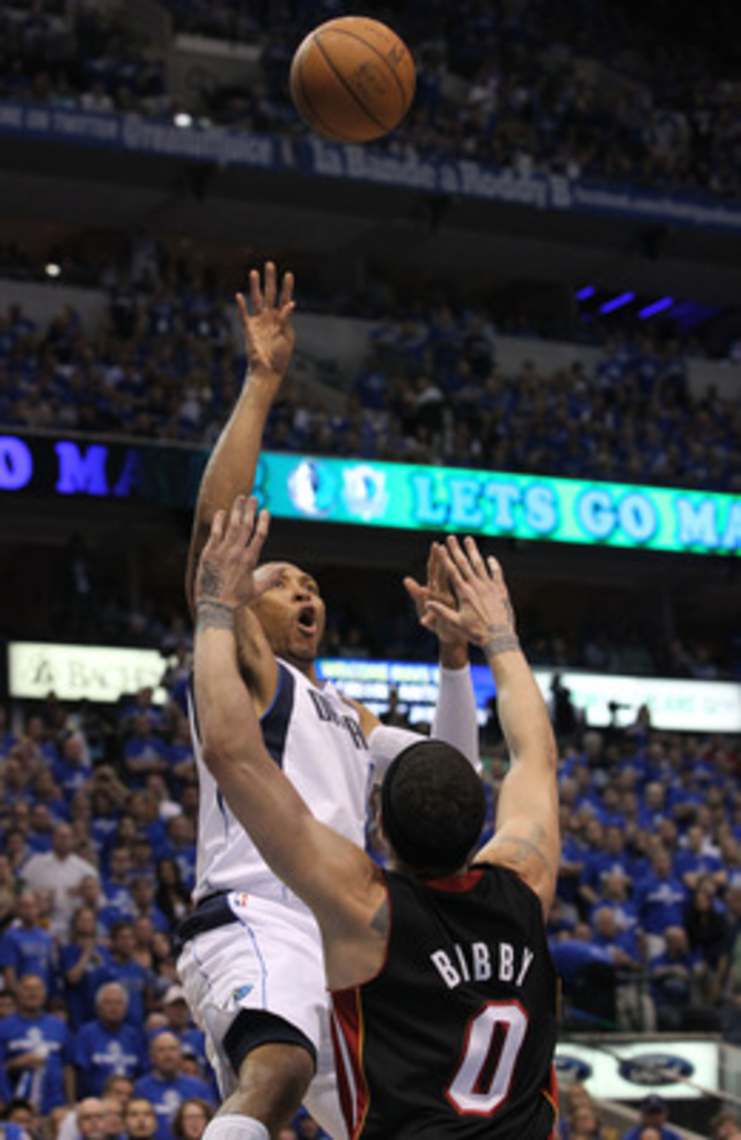 DALLAS, TX - JUNE 09:  Shawn Marion #0 of the Dallas Mavericks attempts a shot in the first half against Mike Bibby #0 of the Miami Heat in Game Five of the 2011 NBA Finals at American Airlines Center on June 9, 2011 in Dallas, Texas.  NOTE TO USER: User