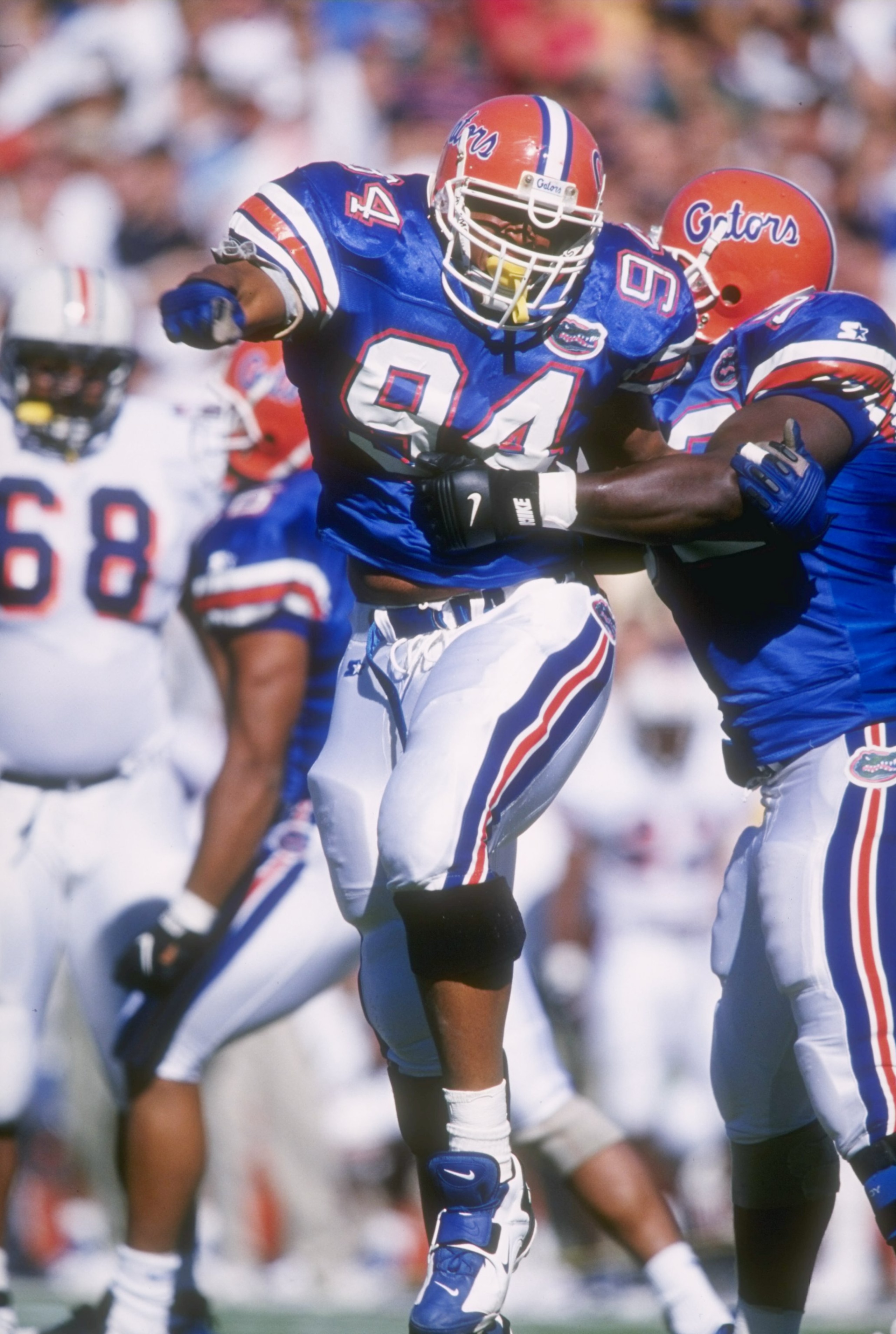 19 Oct 1996:  Defensive lineman Ed Chester #94 of the Florida Gators pumps his fist in celebration as he and teammate Reggie McGrew (left) celebrate a defensive stop of the Auburn Tigers during a play in the Gators 51-10 vicotry over the Tigers at Florida
