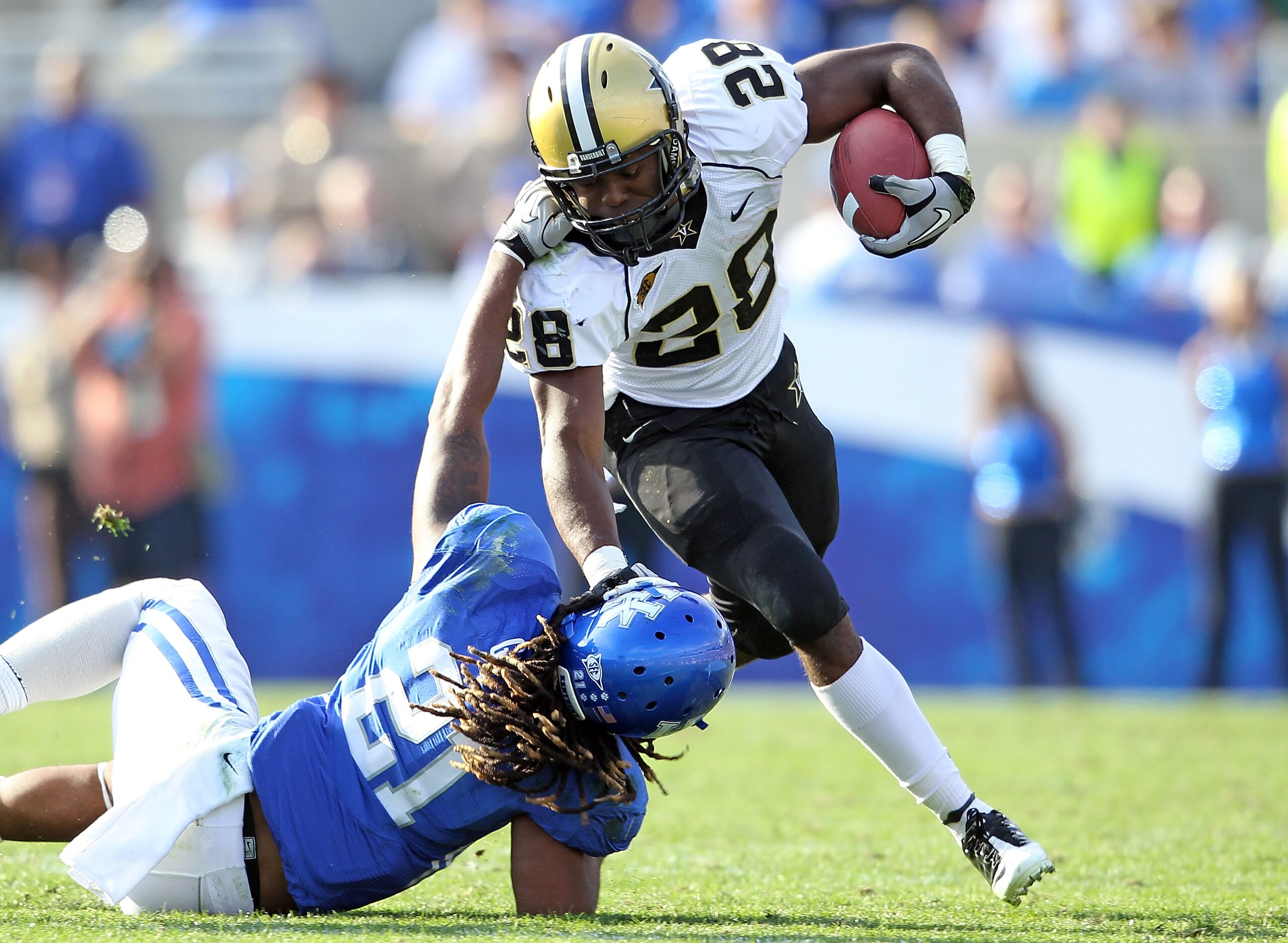 LEXINGTON, KY - NOVEMBER 13: Kennard Reeves # 28 of the Vanderbilt Commodores is tackled by Winston Guy #21 of the Kentucky Wildcats during the game at Commonwealth Stadium on November 13, 2010 in Lexington, Kentucky. (Photo by Andy Lyons/Getty Images) LEXINGTON, KY - NOVEMBER 13: Kennard Reeves # 28 of the Vanderbilt Commodores is tackled by Winston Guy #21 of the Kentucky Wildcats during the game at Commonwealth Stadium on November 13, 2010 in Lexington, Kentucky. (Photo by Andy Lyons/Getty Images)