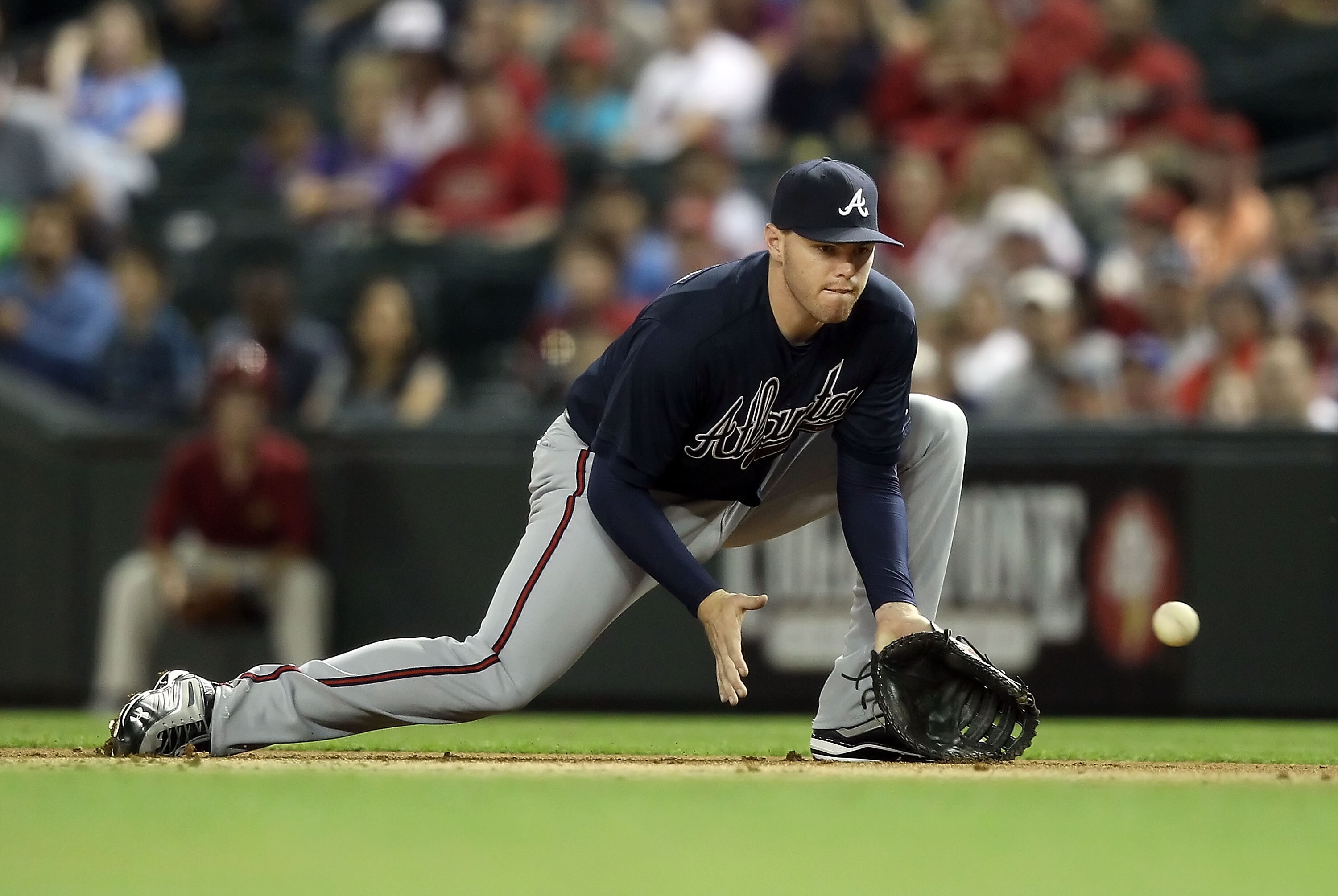 PHOENIX, AZ - MAY 18:  Infielder Freddie Freeman #5 of the Atlanta Braves fields a ground ball out against the Arizona Diamondbacks during the Major League Baseball game at Chase Field on May 18, 2011 in Phoenix, Arizona.  (Photo by Christian Petersen/Get