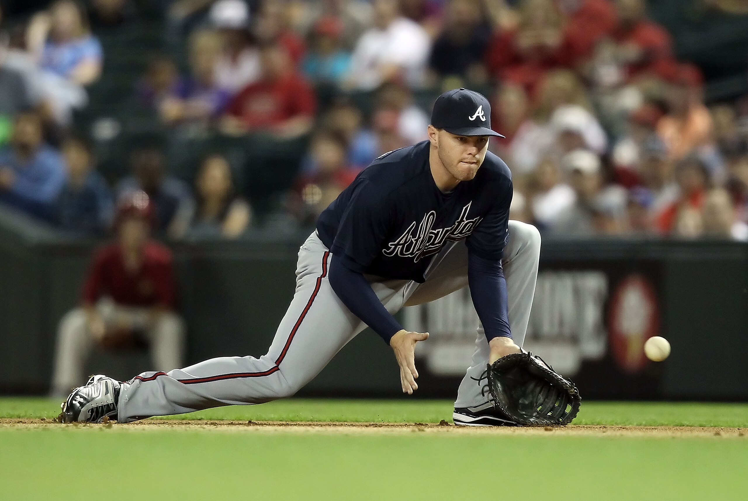 PHOENIX, AZ - MAY 18: Infielder Freddie Freeman #5 of the Atlanta Braves fields a ground ball out against the Arizona Diamondbacks during the Major League Baseball game at Chase Field on May 18, 2011 in Phoenix, Arizona. (Photo by Christian Petersen/Get PHOENIX, AZ - MAY 18: Infielder Freddie Freeman #5 of the Atlanta Braves fields a ground ball out against the Arizona Diamondbacks during the Major League Baseball game at Chase Field on May 18, 2011 in Phoenix, Arizona. (Photo by Christian Petersen/Get