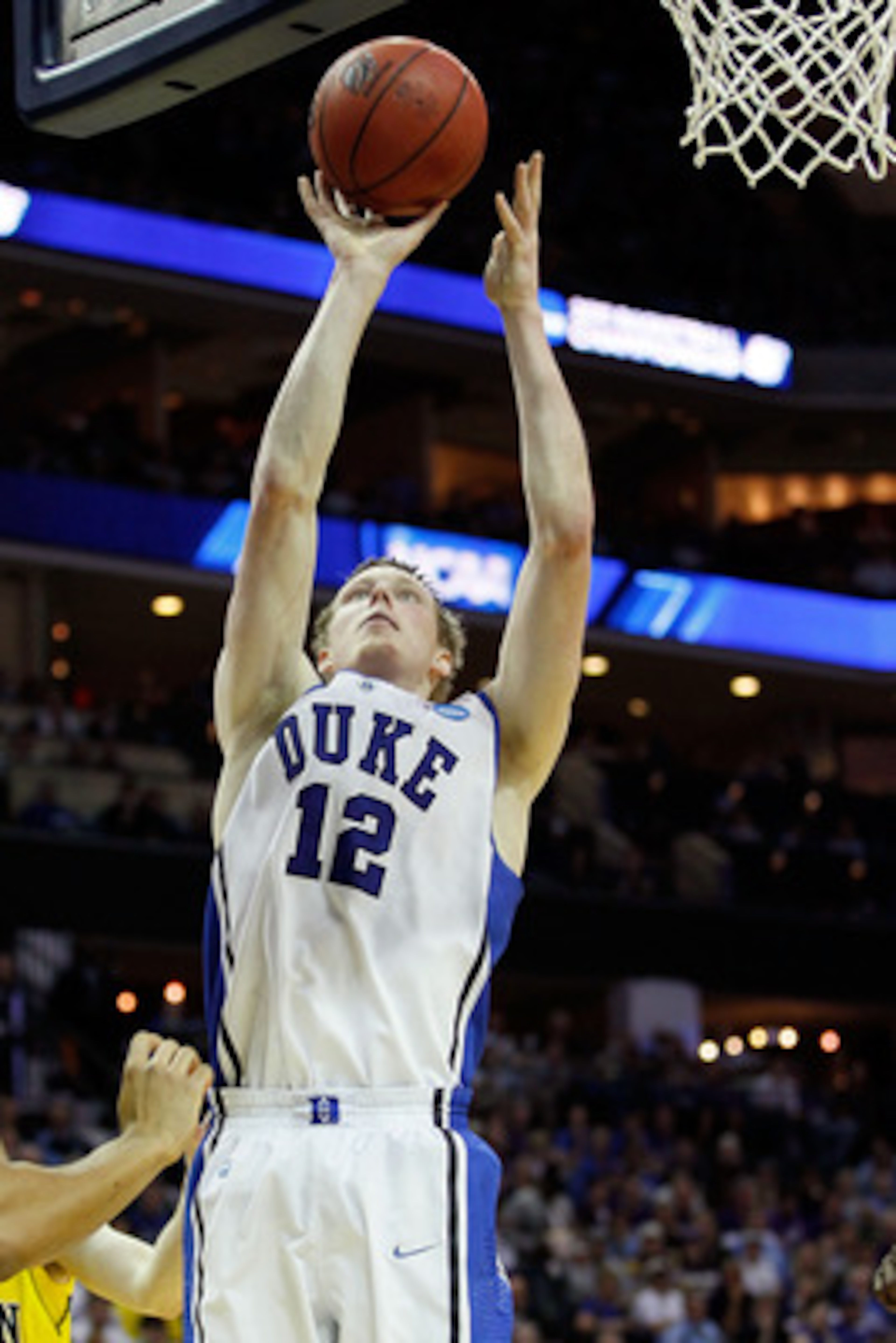 CHARLOTTE, NC - MARCH 20:  Kyle Singler #12 of the Duke Blue Devils lays the ball up while taking on the Michigan Wolverines during the third round of the 2011 NCAA men's basketball tournament at Time Warner Cable Arena on March 20, 2011 in Charlotte, Nor