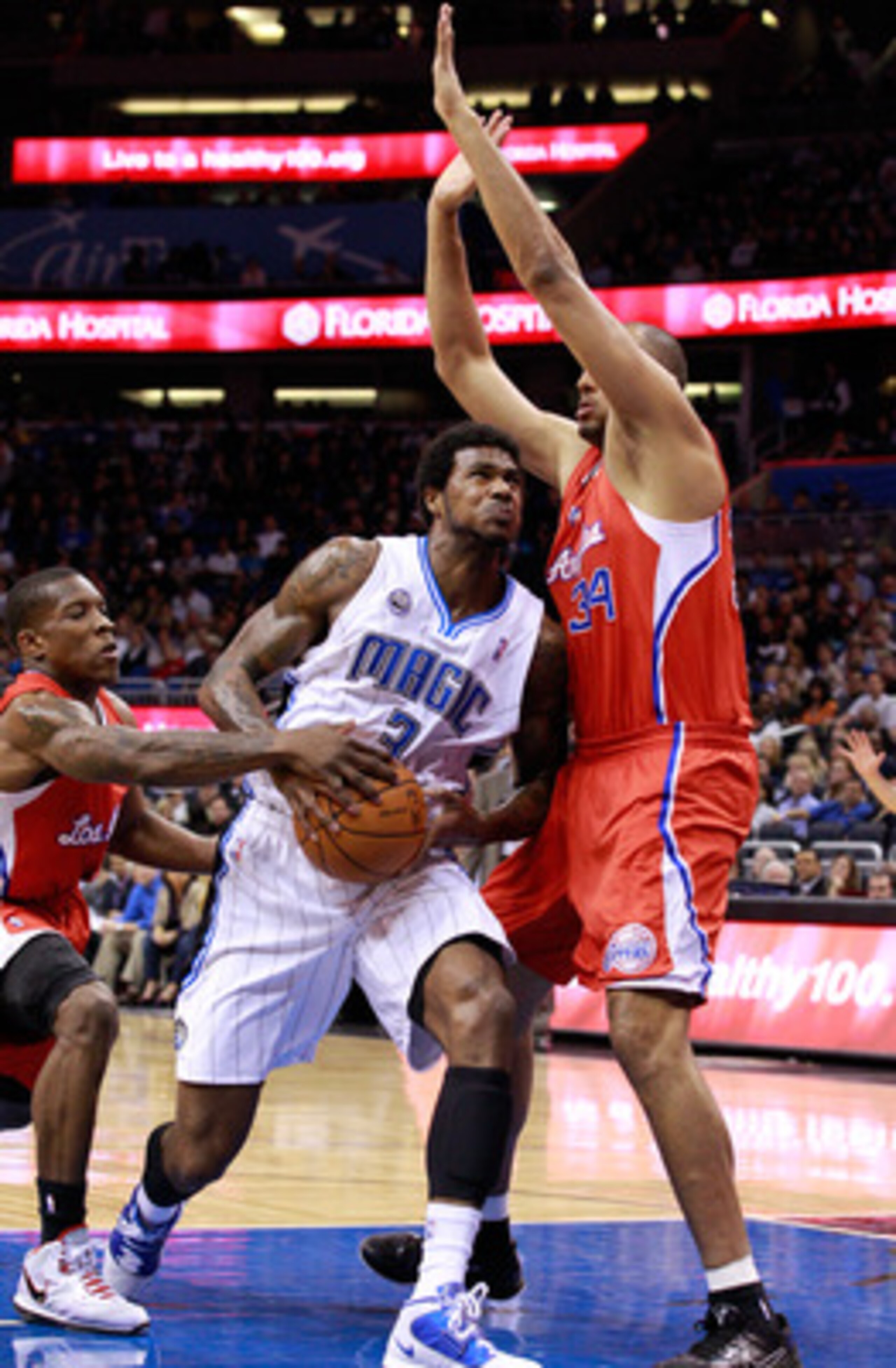 ORLANDO, FL - FEBRUARY 08:  Earl Clark #3 of the Orlando Magic attempts a shot against Brian Cook #34 of the Los Angeles Clippers during the game at Amway Arena on February 8, 2011 in Orlando, Florida.  NOTE TO USER: User expressly acknowledges and agrees