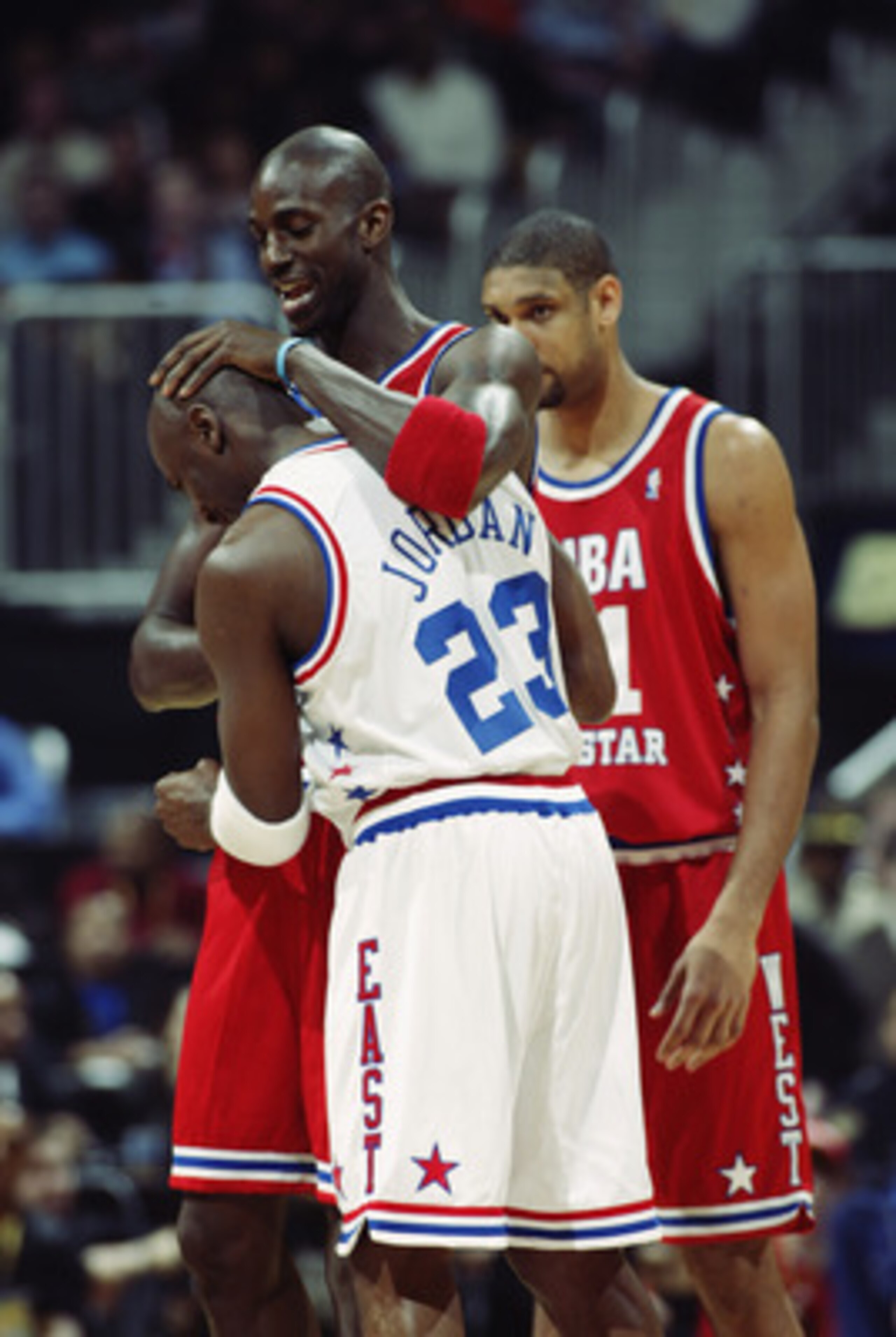 ATLANTA - FEBRUARY 9:  Kevin Garnett (Minnesota Timberwolves) #21 of the Western Conference All-Stars greets Michael Jordan (Washington Wizards) #23 of the Eastern Conference All-Stars before the 2003 NBA All-Star Game on February 9, 2003 at Philips Arena
