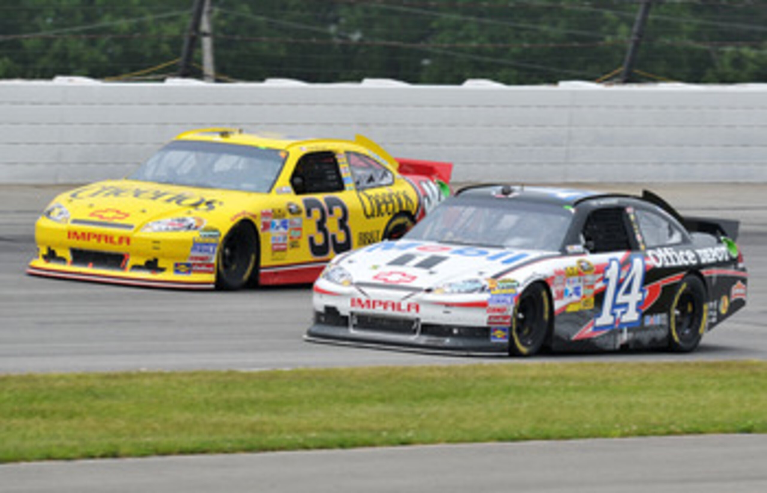 LONG POND, PA - JUNE 12:  Tony Stewart, driver of the #14 Mobil 1/Office Depot Chevrolet, races Clint Bowyer, driver of the #33 Cheerios/Hamburger Helper Chevrolet, during the NASCAR Sprint Cup Series 5-Hour Energy 500 at Pocono Raceway on June 12, 2011 i