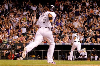 DENVER, CO - JUNE 11: Troy Tulowitzki #2 of the Colorado Rockies prepares to round first base after a two-RBI single to left field scoring in Carlos Gonzalez #5 during the eighth inning against the Los Angeles Dodgers at Coors Field on June 11, 2011 in De