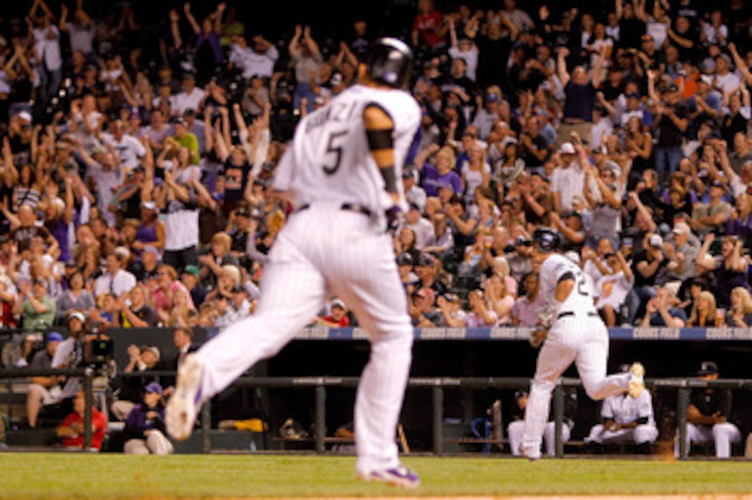 DENVER, CO - JUNE 11: Troy Tulowitzki #2 of the Colorado Rockies prepares to round first base after a two-RBI single to left field scoring in Carlos Gonzalez #5 during the eighth inning against the Los Angeles Dodgers at Coors Field on June 11, 2011 in De DENVER, CO - JUNE 11: Troy Tulowitzki #2 of the Colorado Rockies prepares to round first base after a two-RBI single to left field scoring in Carlos Gonzalez #5 during the eighth inning against the Los Angeles Dodgers at Coors Field on June 11, 2011 in De