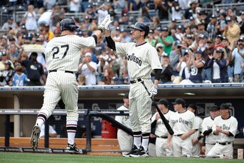 SAN DIEGO, CA - JUNE 11: Anthony Rizzo #27 of the San Diego Padres is congratulated by Brad Hawpe #11after hitting a solo home run during the second inning of a baseball game against the Washington Nationals at Petco Park on June 11, 2011 in San Diego, Ca