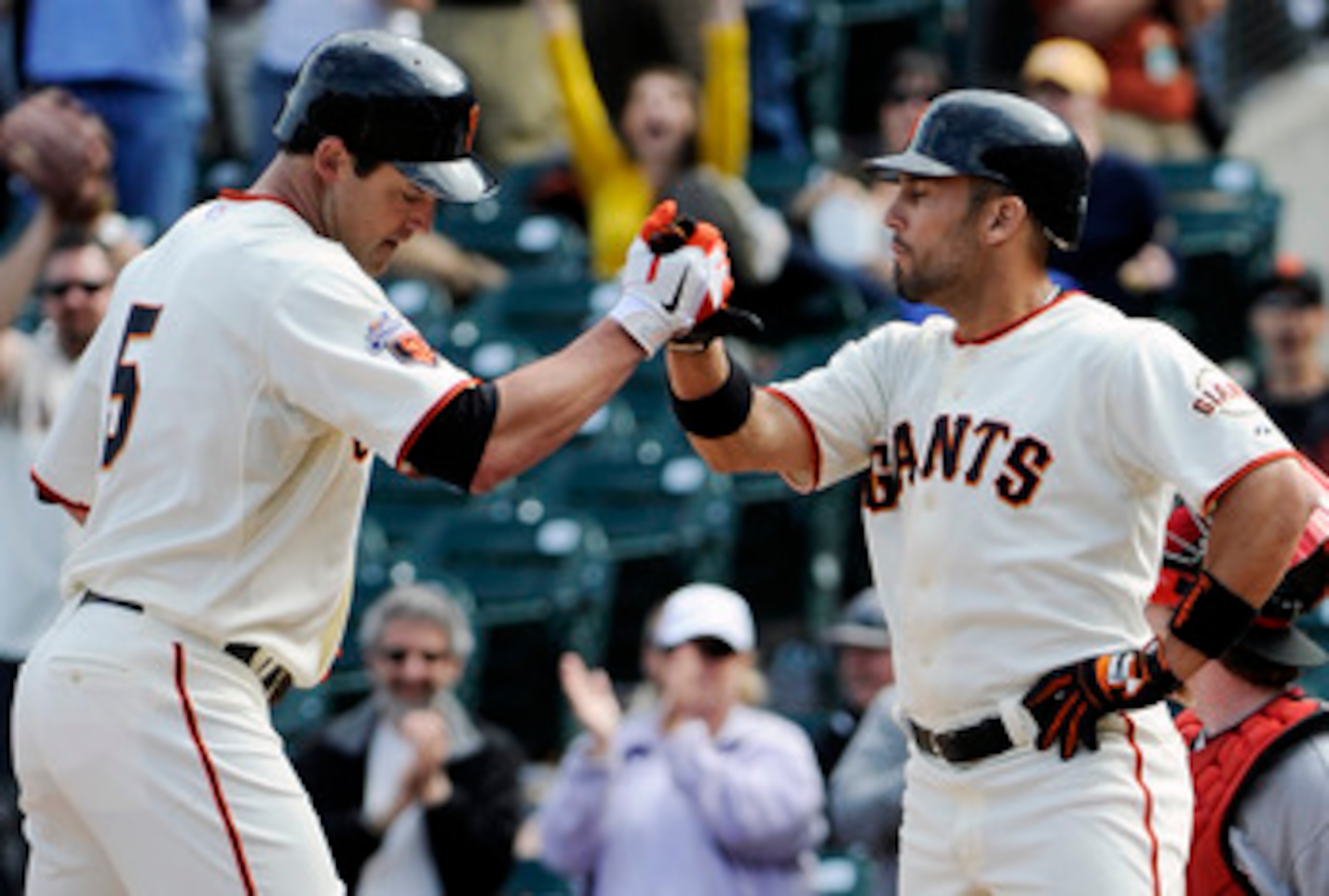 SAN FRANCISCO, CA - JUNE 11: Pat Burrell #5 (L) of the San Francisco Giants is greeted with a high five by teammate Andres Torres #56 (R) after Burrell hit a two run home run in the bottom of the ninth inning against the Cincinnati Reds during a MLB baseb SAN FRANCISCO, CA - JUNE 11: Pat Burrell #5 (L) of the San Francisco Giants is greeted with a high five by teammate Andres Torres #56 (R) after Burrell hit a two run home run in the bottom of the ninth inning against the Cincinnati Reds during a MLB baseb