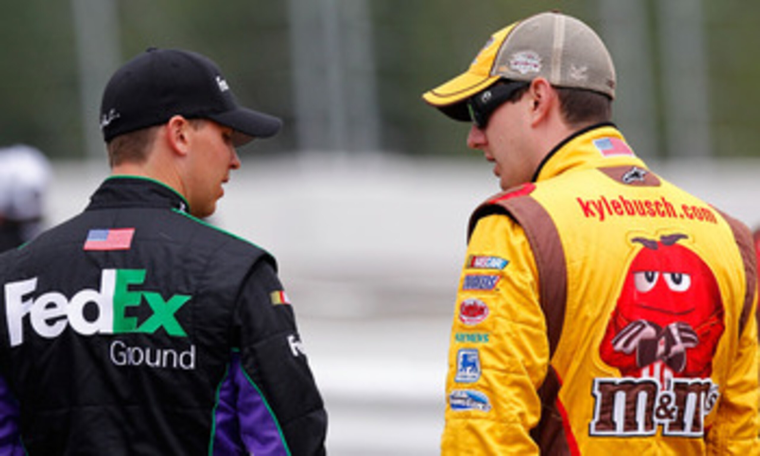 LONG POND, PA - JUNE 11: Kyle Busch (R), driver of the #18 M&M's Toyota, talks with Denny Hamlin, driver of the #11 FedEx Ground Toyota, during qualifying for the NASCAR Sprint Cup Series 5-Hour Energy 500 at Pocono Raceway on June 11, 2011 in Long Pond, 