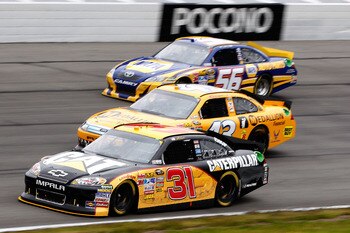 LONG POND, PA - JUNE 12:  Jeff Burton, driver of the #31 Caterpillar Chevrolet, A.J. Allmendinger, driver of the #43 Medallion Financial Ford, and Martin Truex Jr., driver of the #56 NAPA Auto Parts Toyota, race during the NASCAR Sprint Cup Series 5-Hour 
