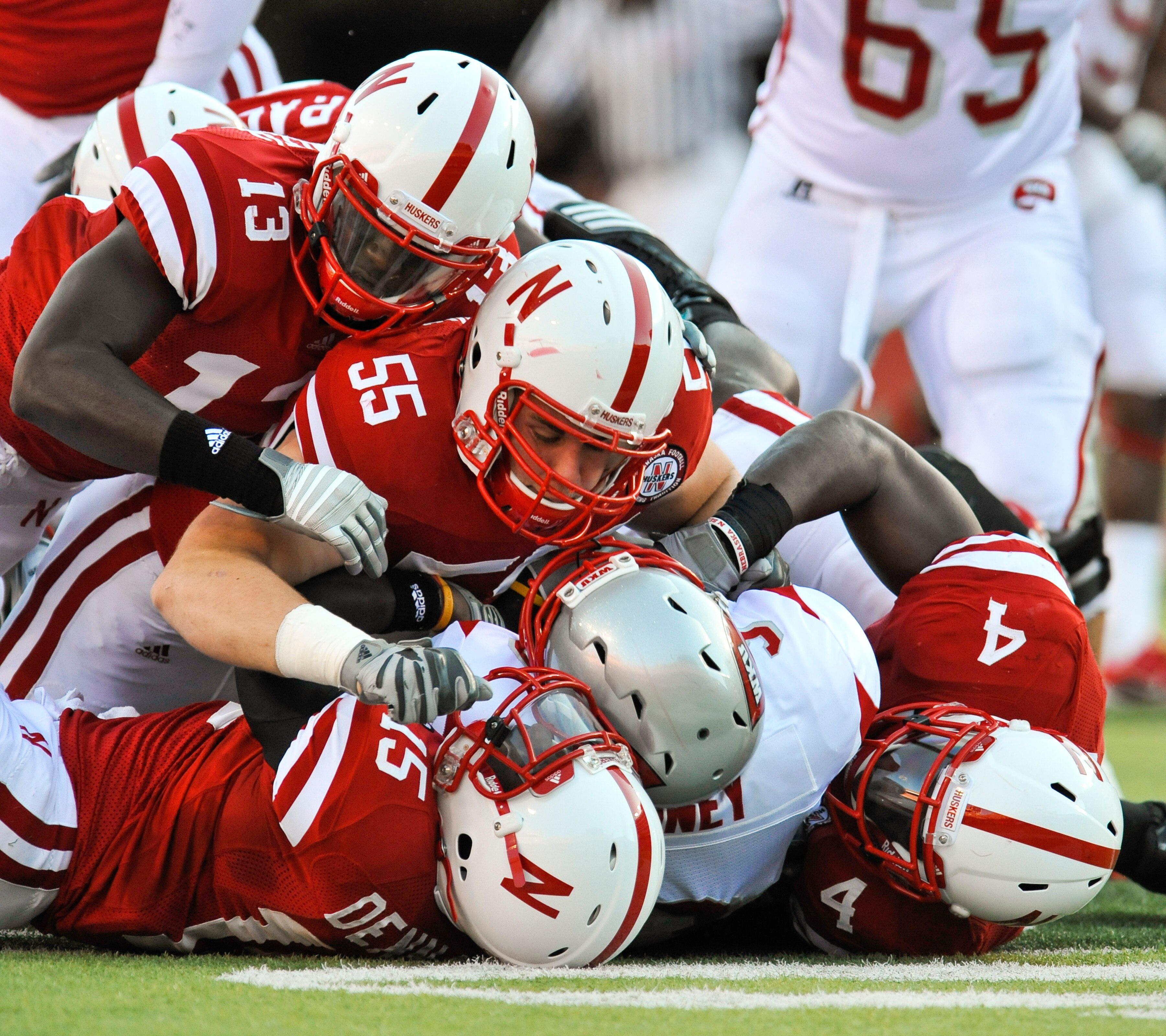 LINCOLN, NE - SEPTEMBER 04:  The Nebraska Cornhuskers  defense swarms Bobby Rainey of the Western Kentucky Hilltoppers during the first half of their game at Memorial Stadium on September 4, 2010 in Lincoln, Nebraska. Nebraska defeated Western Kentucky 49
