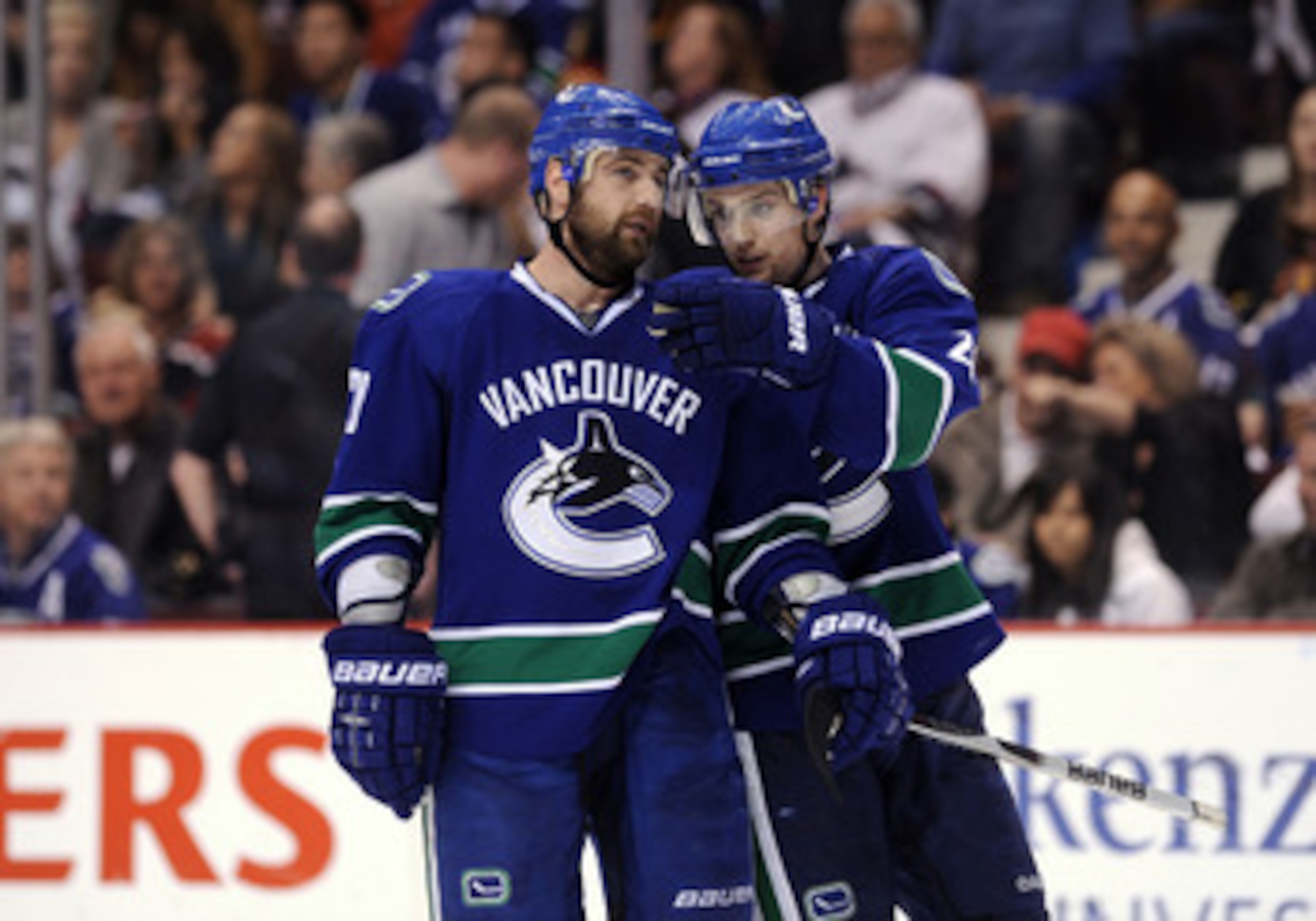 VANCOUVER, CANADA - MAY 18:  Christopher Higgins #20 and Mason Raymond #21 of the Vancouver Canucks confer during a break in Game Two of the Western Conference Finals against San Jose Sharks during the 2011 Stanley Cup Playoffs at Rogers Arena on May 18, 
