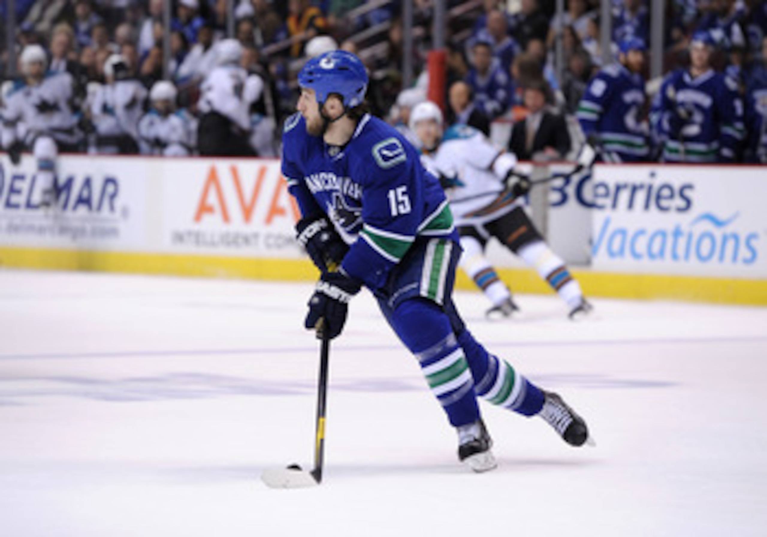 VANCOUVER, CANADA - MAY 15:  Tanner Glass #15 of the Vancouver Canucks looks to pass the puck out of the defensive zone against the San Jose Sharks in the first period in Game One of the Western Conference Finals during the 2011 Stanley Cup Playoffs at Ro
