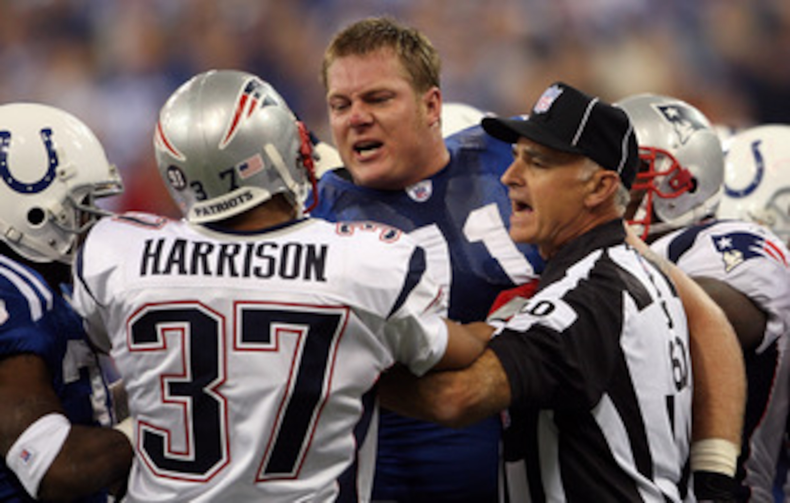INDIANAPOLIS - NOVEMBER 04:  Line judge Gary Cavaletto #60 attempts to seperate Ryan Diem #71 of the Indianapolis Colts and Rodney Harrison #37 of the New England Patriots during the first quarter of their game on November 4, 2007 at the RCA Dome in India
