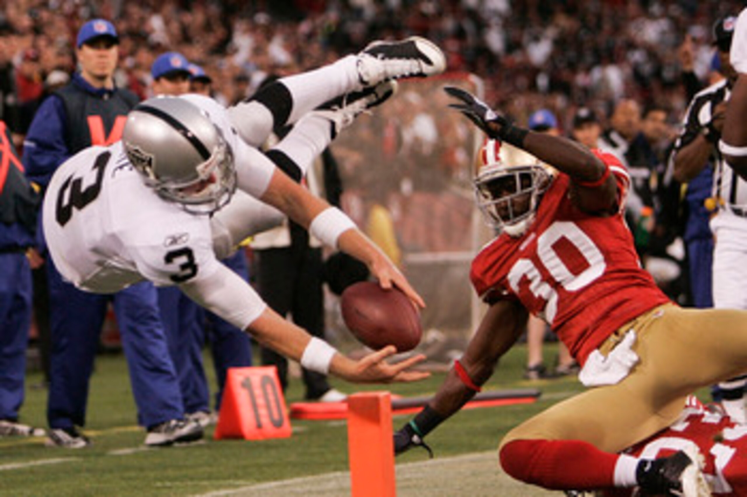 SAN FRANCISCO - AUGUST 22: Oakland Raiders quarterback Charlie Frye #3 dives into the end zone for a touch down as San Francisco 49ers safety Reggie Smith tries to take him down as the San Francisco 49ers host the Oakland Raiders at Candlestick Park Augu SAN FRANCISCO - AUGUST 22: Oakland Raiders quarterback Charlie Frye #3 dives into the end zone for a touch down as San Francisco 49ers safety Reggie Smith tries to take him down as the San Francisco 49ers host the Oakland Raiders at Candlestick Park Augu