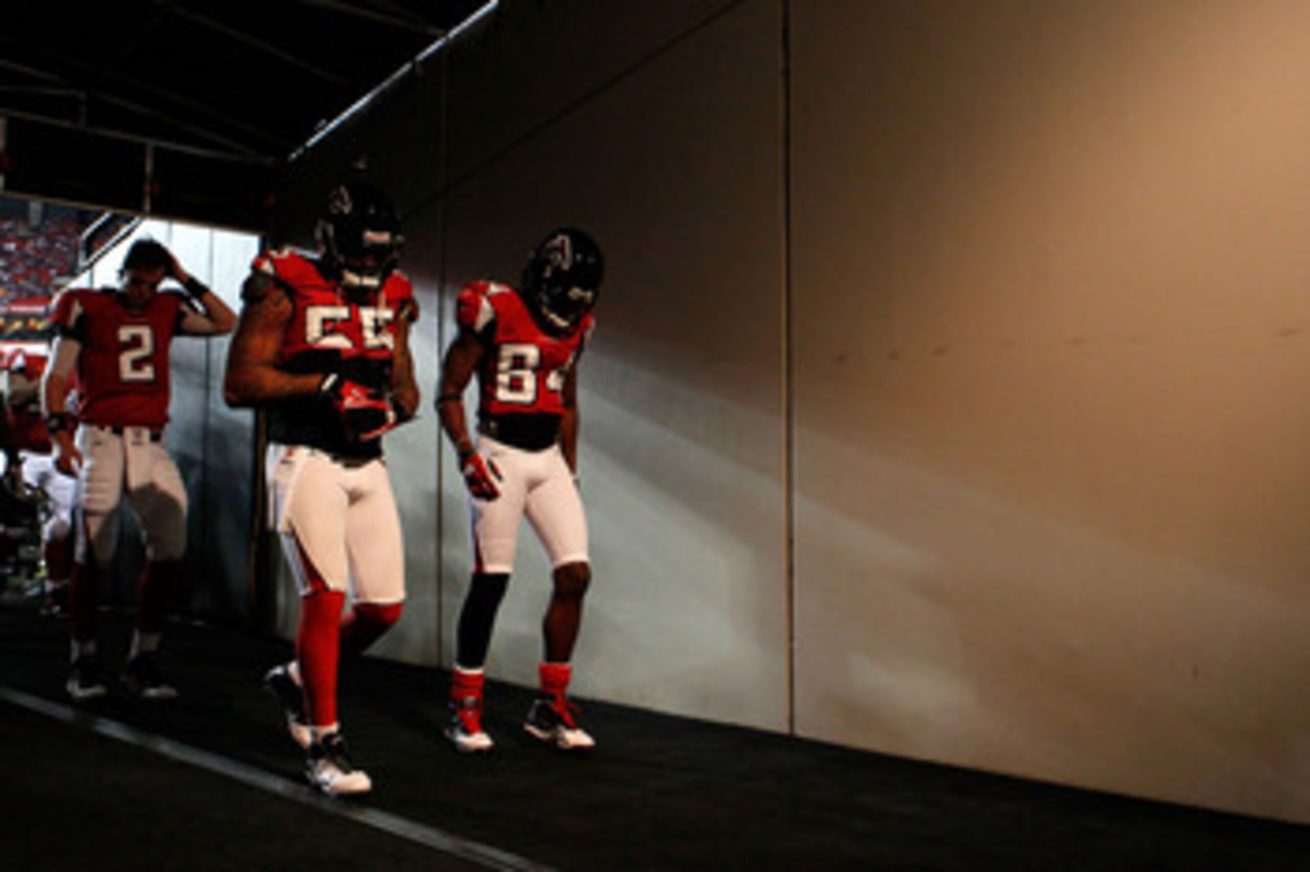 ATLANTA, GA - JANUARY 15:  (L-R) Quarterback Matt Ryan #2, John Abraham #55 and Roddy White #84 of the Atlanta Falcons walk to the locker room from the field following warm ups against the Green Bay Packers during their 2011 NFC divisional playoff game at