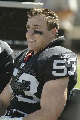 OAKLAND, CA - SEPTEMBER  8:  Linebacker Bill Romanowski #53 of the Oakland Raiders looks on from the bench during the game against the Seattle Seahawks on September 8, 2002 at Network Associates Coliseum in Oakland, California. The Raiders won 31-17. (Pho