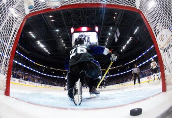TAMPA, FL - MAY 25:  The puck shot by Steven Stamkos #91 of the Tampa Bay Lightning for a third period goal is seen in the net as Martin St. Louis #26 of the Tampa Bay Lightning climbs out in Game Six of the Eastern Conference Finals against the Boston Br