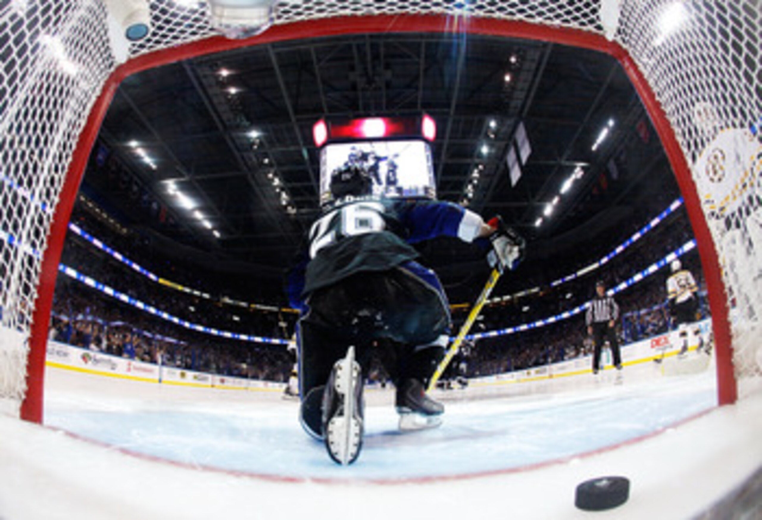 TAMPA, FL - MAY 25:  The puck shot by Steven Stamkos #91 of the Tampa Bay Lightning for a third period goal is seen in the net as Martin St. Louis #26 of the Tampa Bay Lightning climbs out in Game Six of the Eastern Conference Finals against the Boston Br