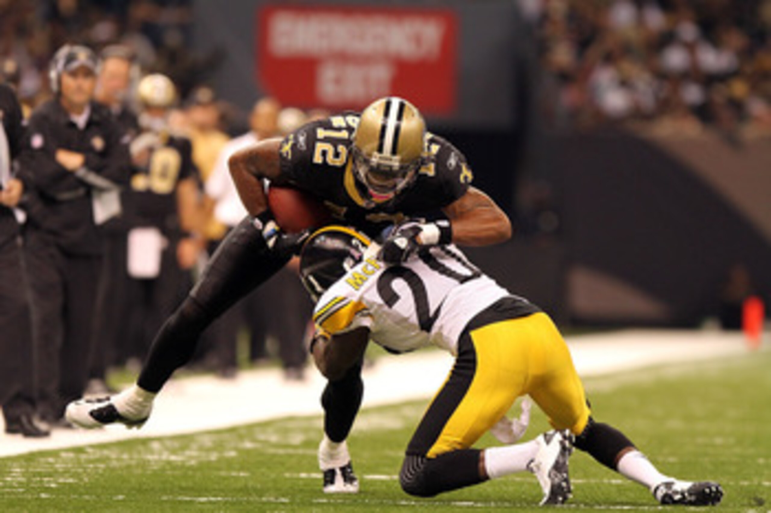 NEW ORLEANS, LA - OCTOBER 31: Marques Colston #12 of the New Orleans Saints is tackled by Bryant McFadden #20 of the Pittsburgh Steelers at the Louisiana Superdome on October 31, 2010 in New Orleans, Louisiana. (Photo by Matthew Sharpe/Getty Images)