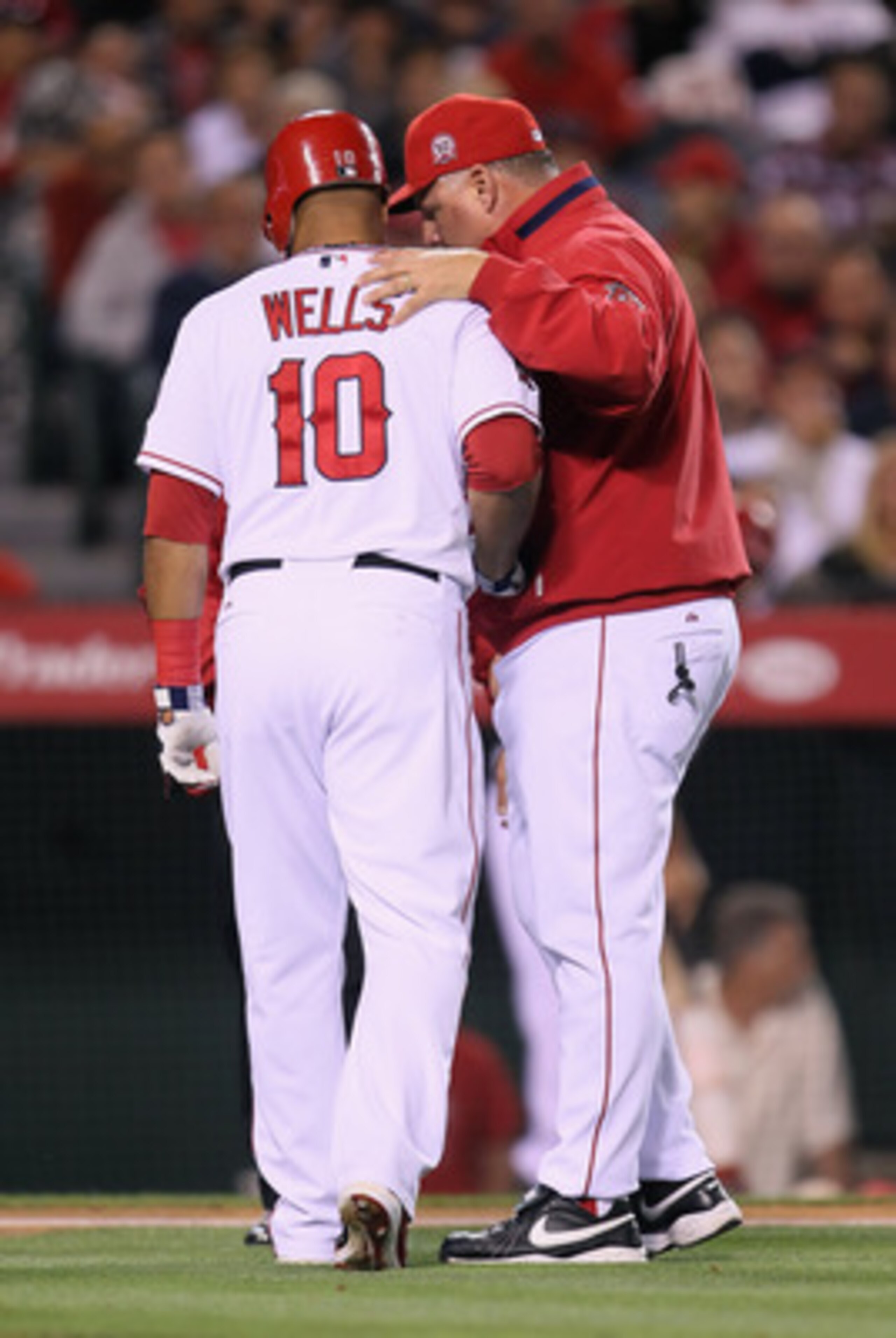 ANAHEIM, CA - MAY 09:  Vernon Wells #10 of the Los Angeles Angels of Anaheim is helped off the field by manager Mike Scioscia after Wells strained his groin while at bat against the Chicago White Sox in the fourth inning at Angel Stadium of Anaheim on May