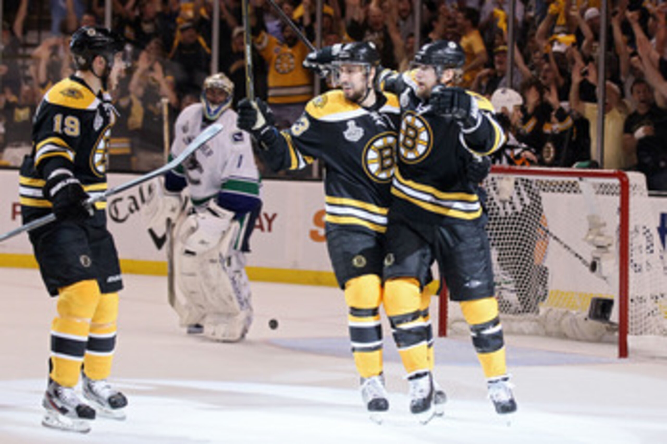 BOSTON, MA - JUNE 08:  Michael Ryder #73 of the Boston Bruins celebrates with his teammates Chris Kelly #23 and Tyler Seguin #19 after scoring a goal in the second period against Roberto Luongo #1 of the Vancouver Canucks during Game Four of the 2011 NHL 