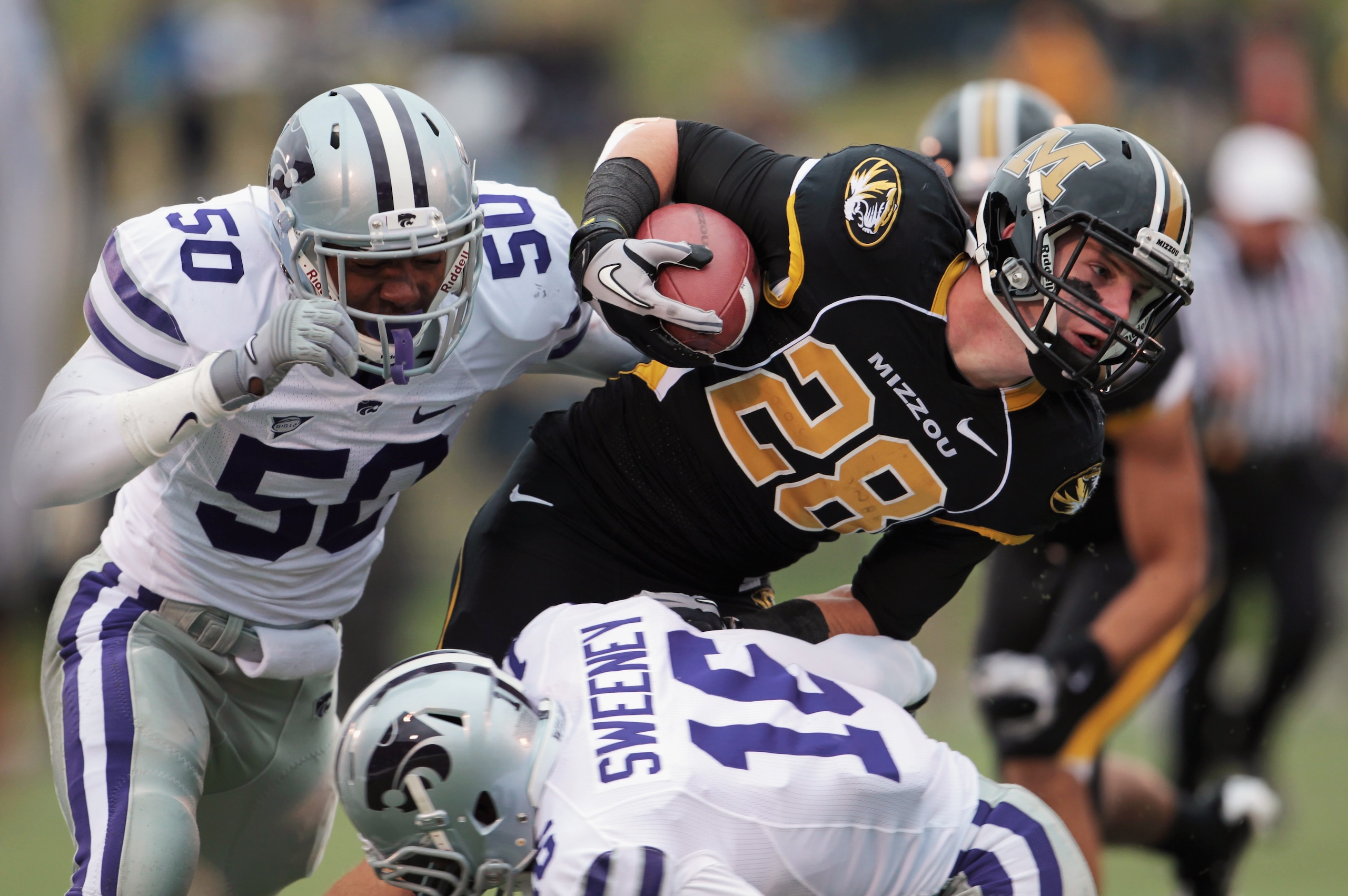 COLUMBIA, MO - NOVEMBER 13:  Receiver T.J. Moe #28 of the Missouri Tigers carries the ball as Tre Walker #50 and Terrance Sweeney #16 of the Kansas State Wildcats defend during the game on November 13, 2010 at Faurot Field/Memorial Stadium in Columbia, Mi