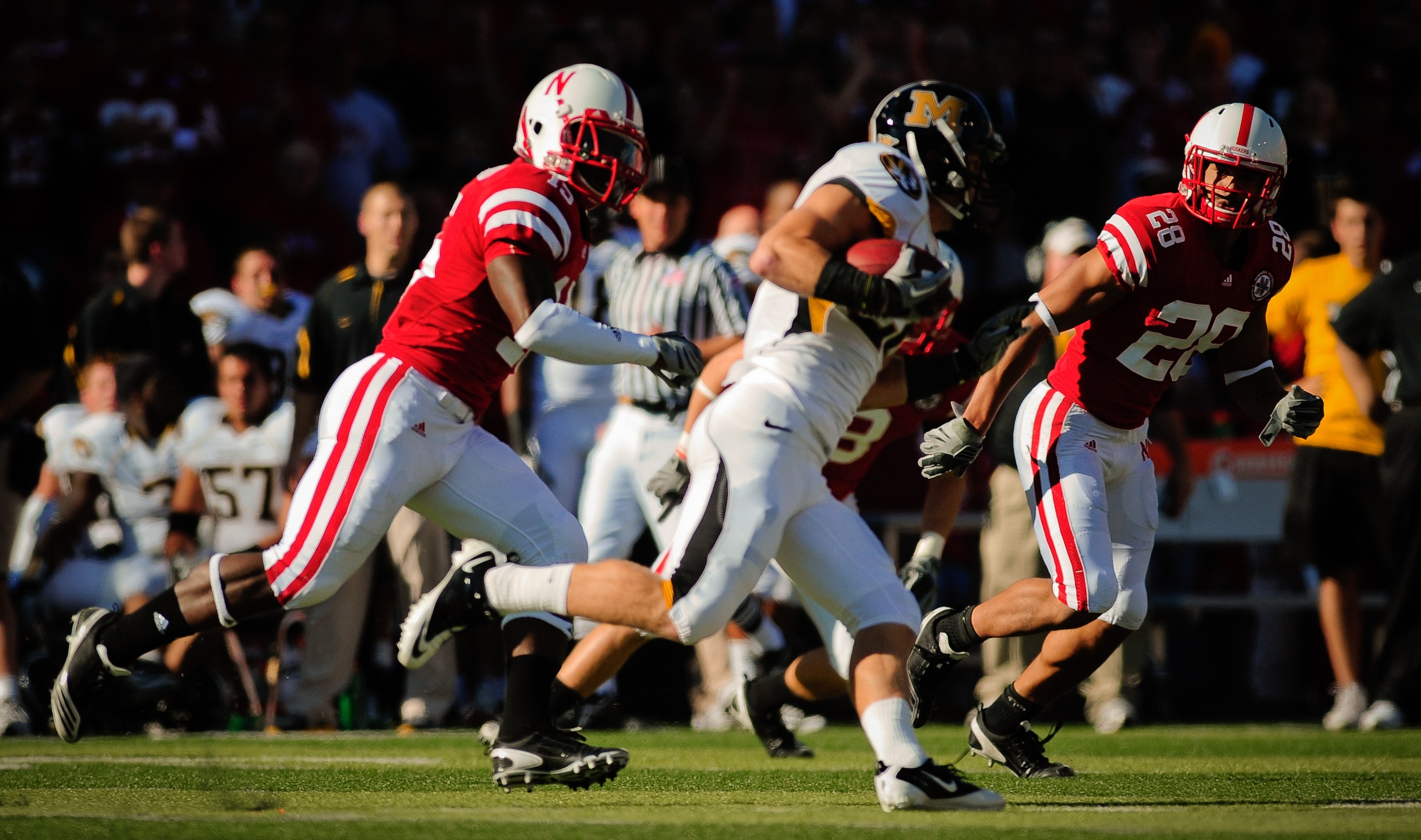 LINCOLN, NE - OCTOBER 30: Defensive back Eric Hagg #28 and teammate cornerback Alfonzo Dennard #15 of the Nebraska Cornhuskers take aim at wide receiver T.J. Moe #28 of the Missouri Tigers during first half action of their game at Memorial Stadium on Octo