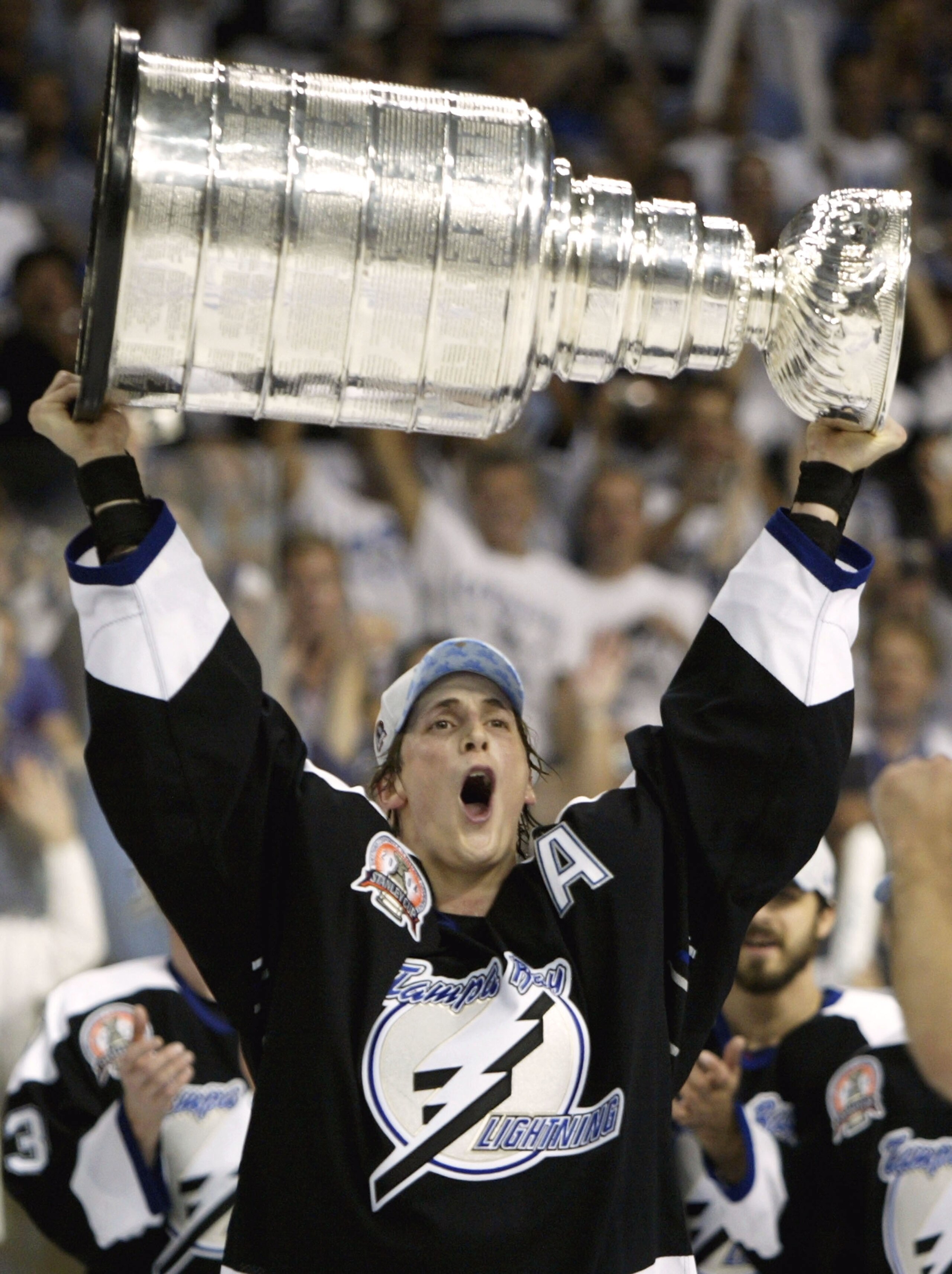 TAMPA, FL - JUNE 7:   Vincent Lecavalier #4 of the Tampa Bay Lightning skates with the Stanley Cup after defeating the Calgary Flames in game seven of the NHL Stanley Cup Finals on June 7, 2004 at the St. Pete Times Forum in Tampa, Florida. The Lightning