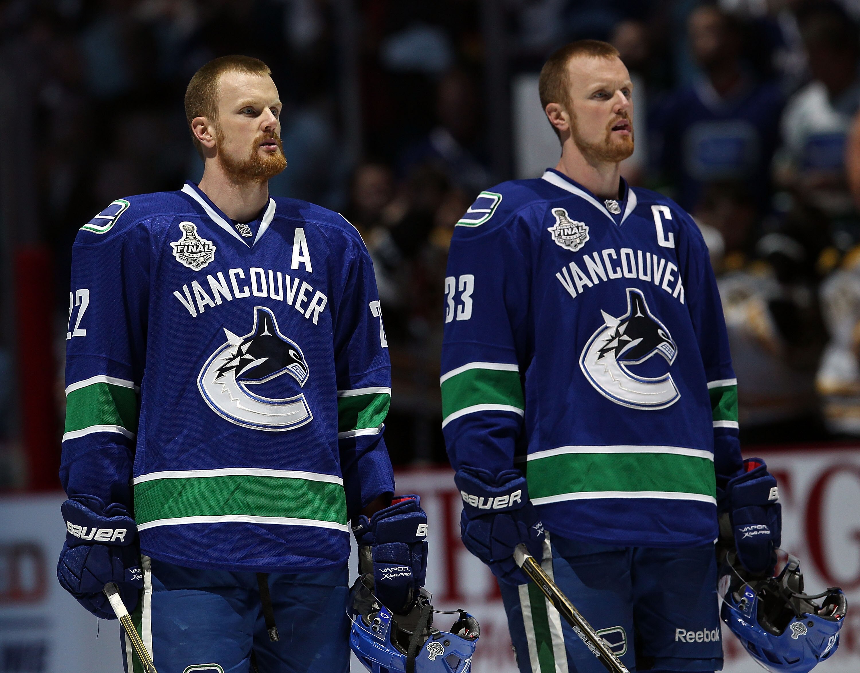 VANCOUVER, BC - JUNE 10:  Daniel Sedin #22 and Henrik Sedin #33 of the Vancouver Canucks look on prior to Game Five of the 2011 NHL Stanley Cup Final at Rogers Arena on June 10, 2011 in Vancouver, British Columbia, Canada.  (Photo by Bruce Bennett/Getty I