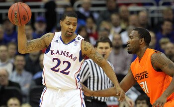 KANSAS CITY, MO - MARCH 10:  Marcus Morris #22 of the Kansas Jayhawks looks to move the ball against Matt Pilgrim #31 of the Oklahoma State Cowboys during their quarterfinal game in the 2011 Phillips 66 Big 12 Men's Basketball Tournament at Sprint Center 