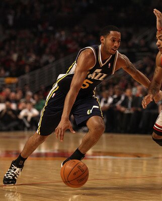 CHICAGO, IL - MARCH 12: Devin Harris #5 of the Utah Jazz drives against Derrick Rose #1 of the Chicago Bulls at the United Center on March 12, 2011 in Chicago, Illinois. The Bulls defeated the Jazz 118-100. NOTE TO USER: User expressly acknowledges and ag