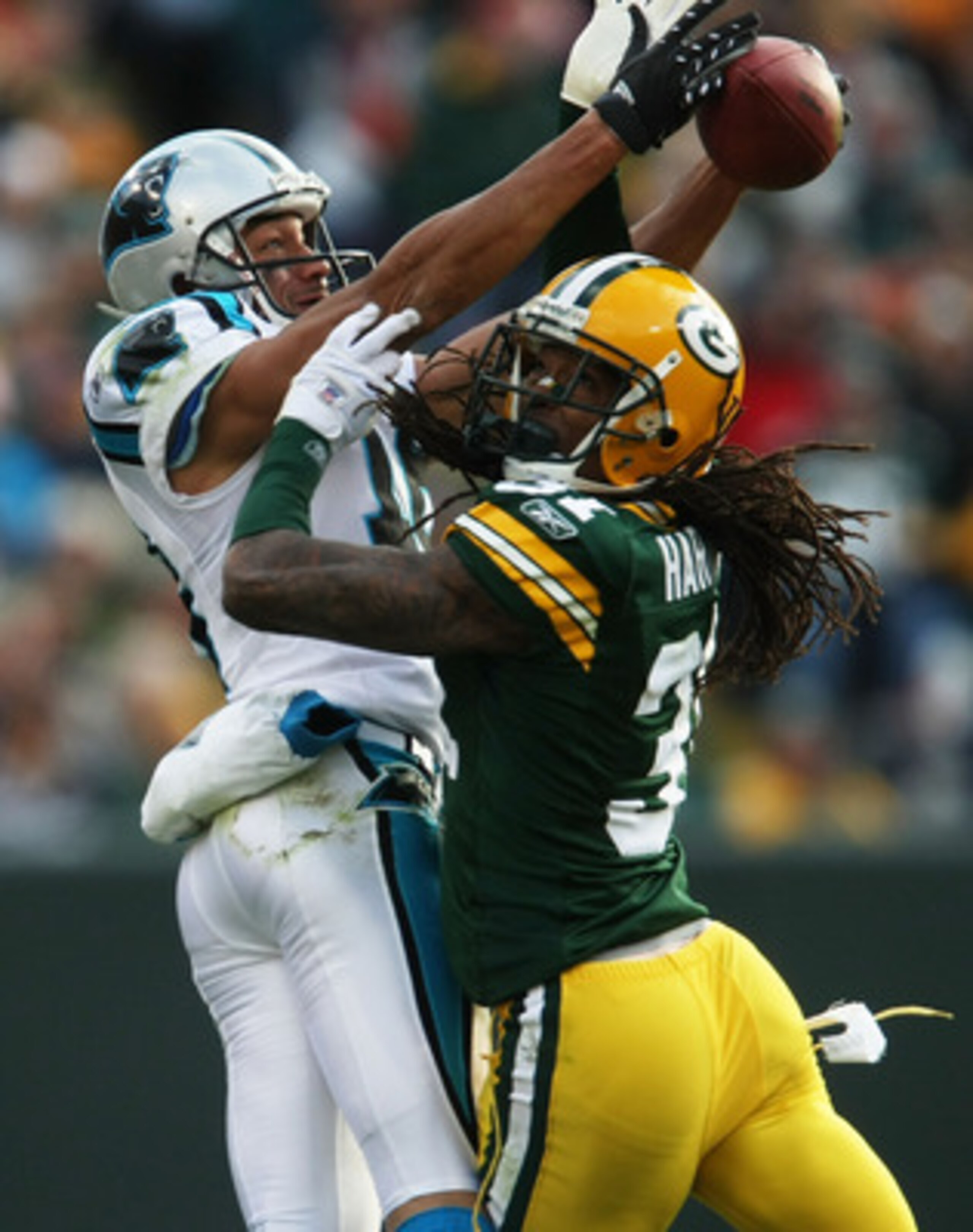 GREEN BAY, WI - NOVEMBER 18: Drew Carter #18 of the Carolina Panthers makes a catch as Al Harris #31 of the Green Bay Packers defends on November 18, 2007 at Lambeau Field in Green Bay, Wisconsin. The Packers defeated the Panthers 31-17. (Photo by Jonatha