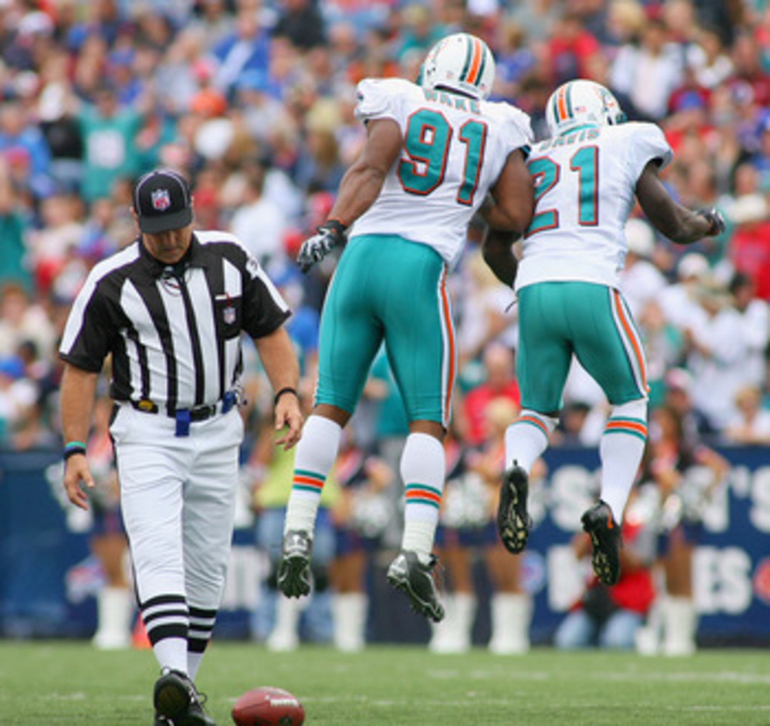 ORCHARD PARK, NY - SEPTEMBER 12: Cameron Wake #91 and Vontae Davis #21 of the Miami Dolphins celebrate a sack against the Buffalo Bills  during the NFL season opener at Ralph Wilson Stadium on September 12, 2010 in Orchard Park, New York.  Miami won 15-10