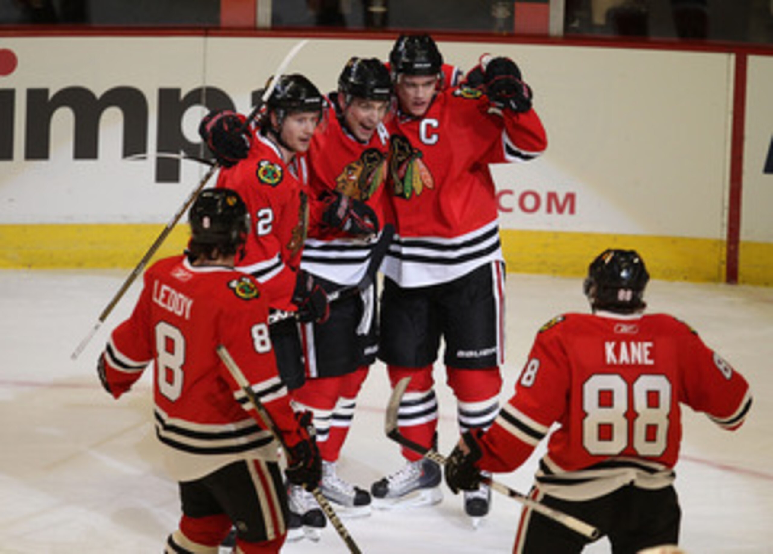 CHICAGO, IL - MARCH 02: (L-R) Nick Leddy #8, Duncan Keith #2, Patrick Sharp #10 and Jonathan Toews #19 of the Chicago Blackhawks welcome teammate Patrick Kane #88 to celebrate Toew's goal against the Calgary Flames at the United Center on March 2, 2011 in