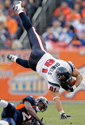 DENVER - DECEMBER 26: Owen Daniels #81 of the Houston Texans gets up-ended by Andre' Goodman #21 of the Denver Broncos during the first quarter at INVESCO Field at Mile High on December 26, 2010 in Denver, Colorado. (Photo by Justin Edmonds/Getty Images)