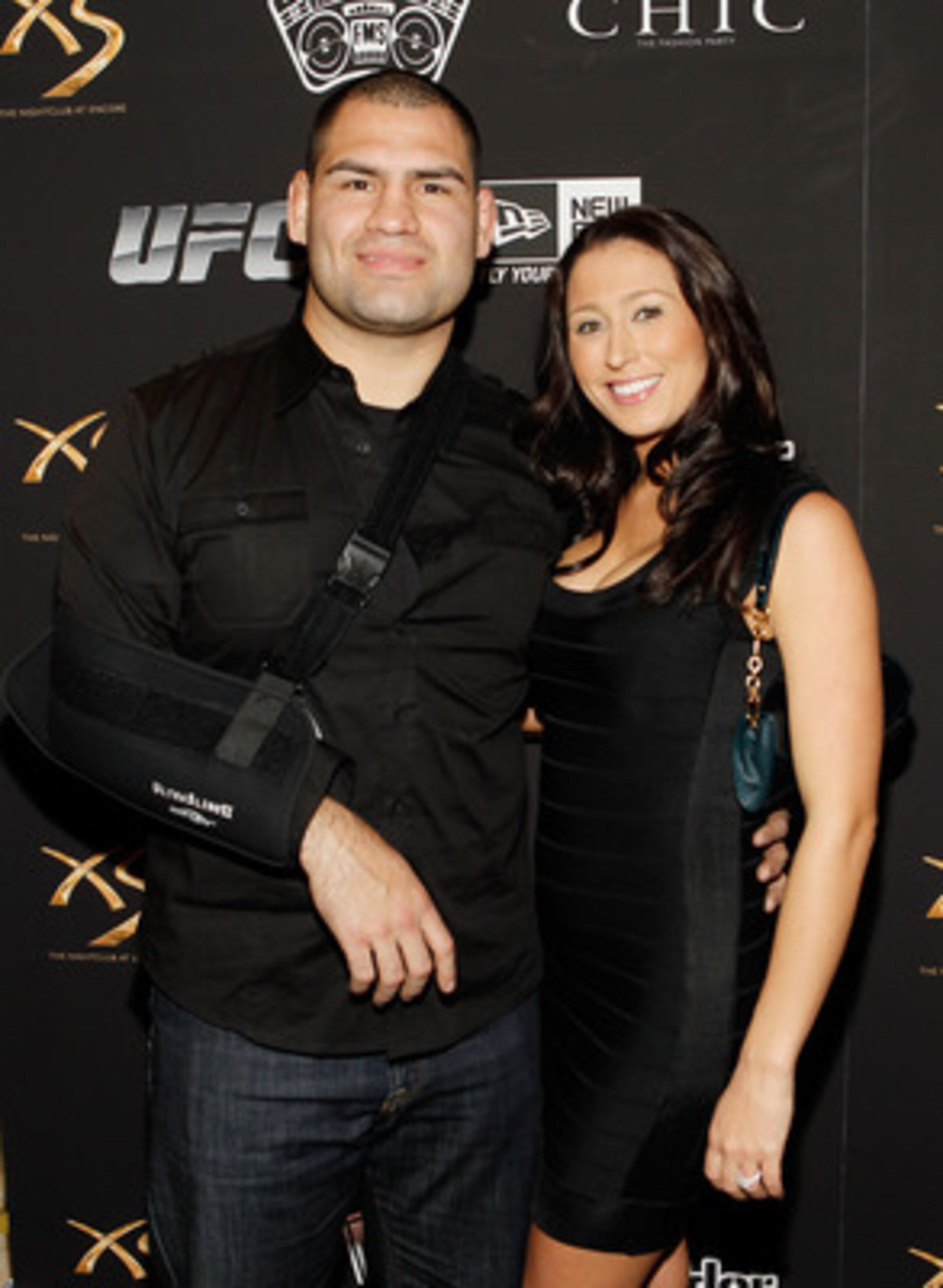 LAS VEGAS - FEBRUARY 15:  UFC fighter Cain Velasquez, left, and his fiance' Michelle Borquez arrive at UFC, Famous Stars and Straps and New Era's 'The Magic Party' at XS the nightclub on February 15, 2011 in Las Vegas, Nevada.  (Photo by Isaac Brekken/Get