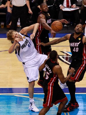 DALLAS, TX - JUNE 09:  Dirk Nowitzki #41 of the Dallas Mavericks loses the ball as he drives against Mario Chalmers #15, Dwyae Wade #3 and Udonis Haslem #40 of the Miami Heat in the second half of Game Five of the 2011 NBA Finals at American Airlines Cent
