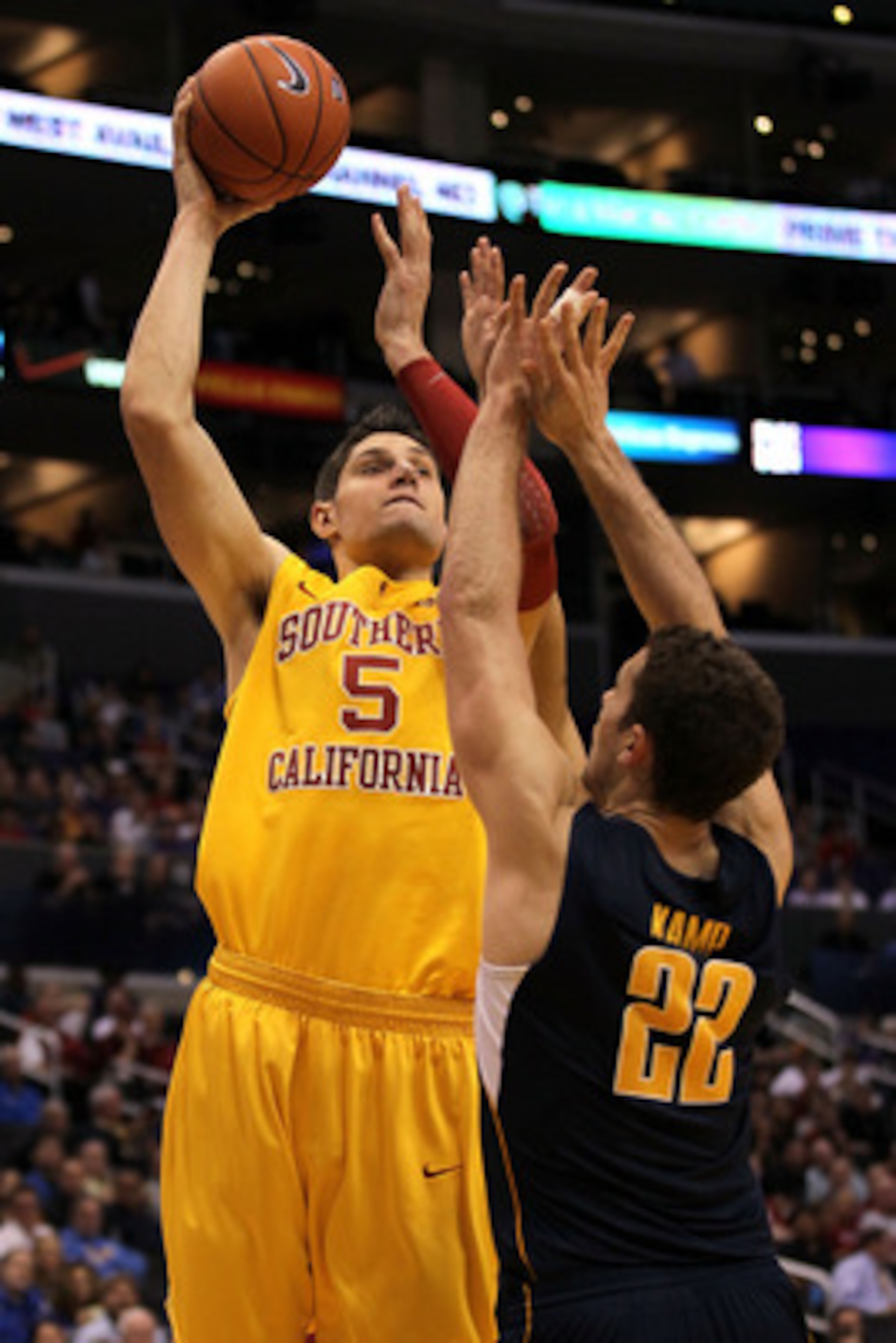 LOS ANGELES, CA - MARCH 10:  Nikola Vucevic #5 of the USC Trojans shoots over Harper Kamp #22 of the California Golden Bears in the second half in the quarterfinals of the 2011 Pacific Life Pac-10 Men's Basketball Tournament at Staples Center on March 10,