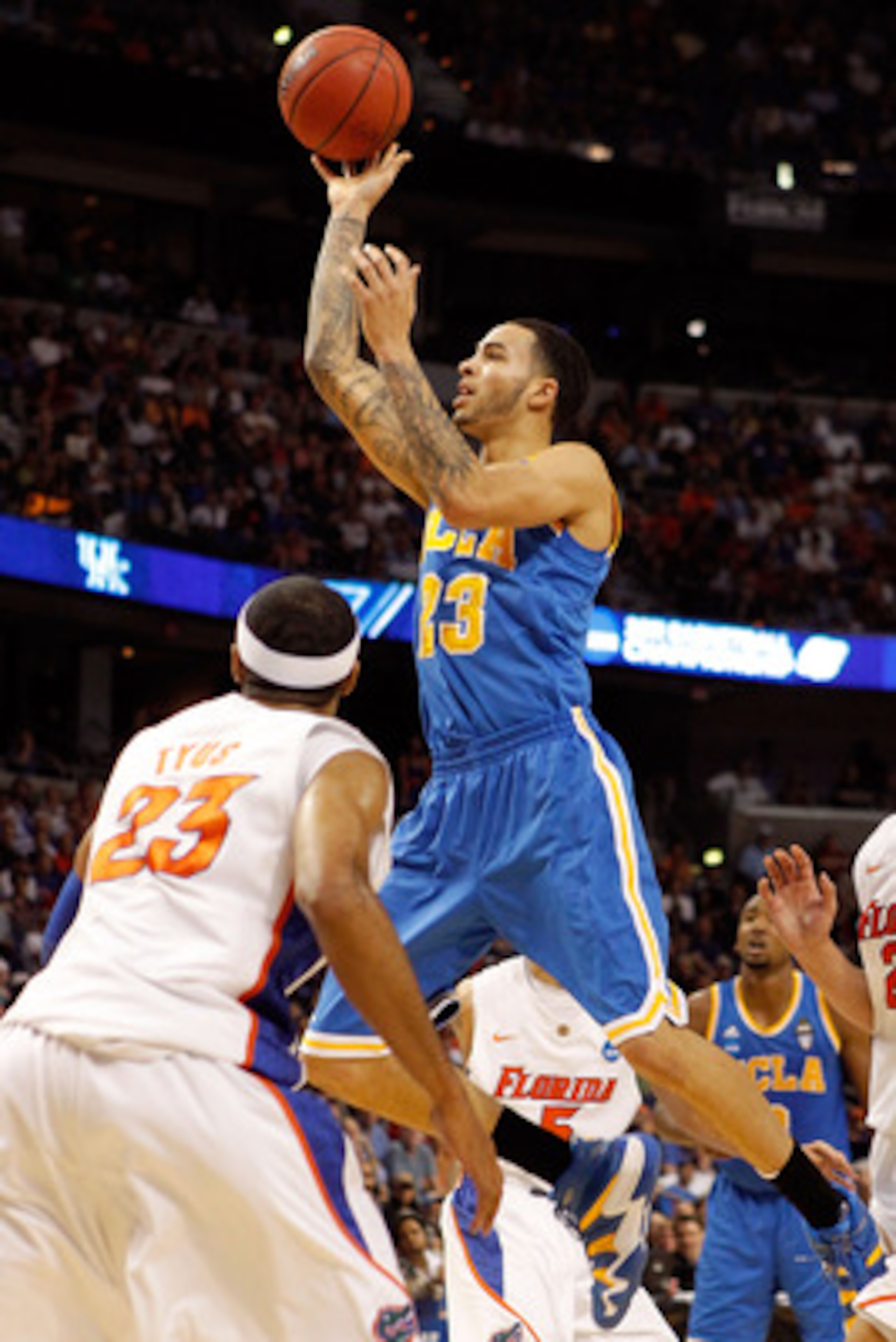 TAMPA, FL - MARCH 19:  Tyler Honeycutt #23 of the UCLA Bruins drives for a shot attempt against Alex Tyus #23 of the Florida Gators during the third round of the 2011 NCAA men's basketball tournament at St. Pete Times Forum on March 19, 2011 in Tampa, Flo