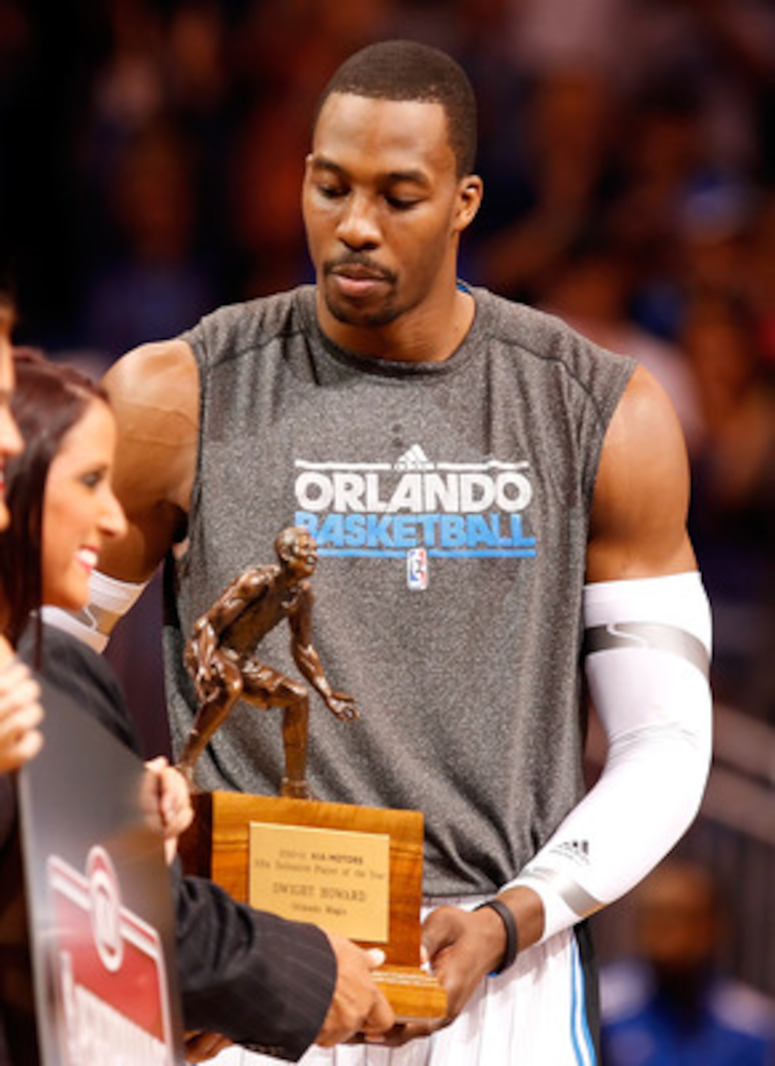 ORLANDO, FL - APRIL 19:  Dwight Howard #12 of the Orlando Magic receives his Defensive Player of the Year award just before the start of Game Two of the Eastern Conference Quarterfinals of the 2011 NBA Playoffs against the Atlanta Hawks on April 19, 2011