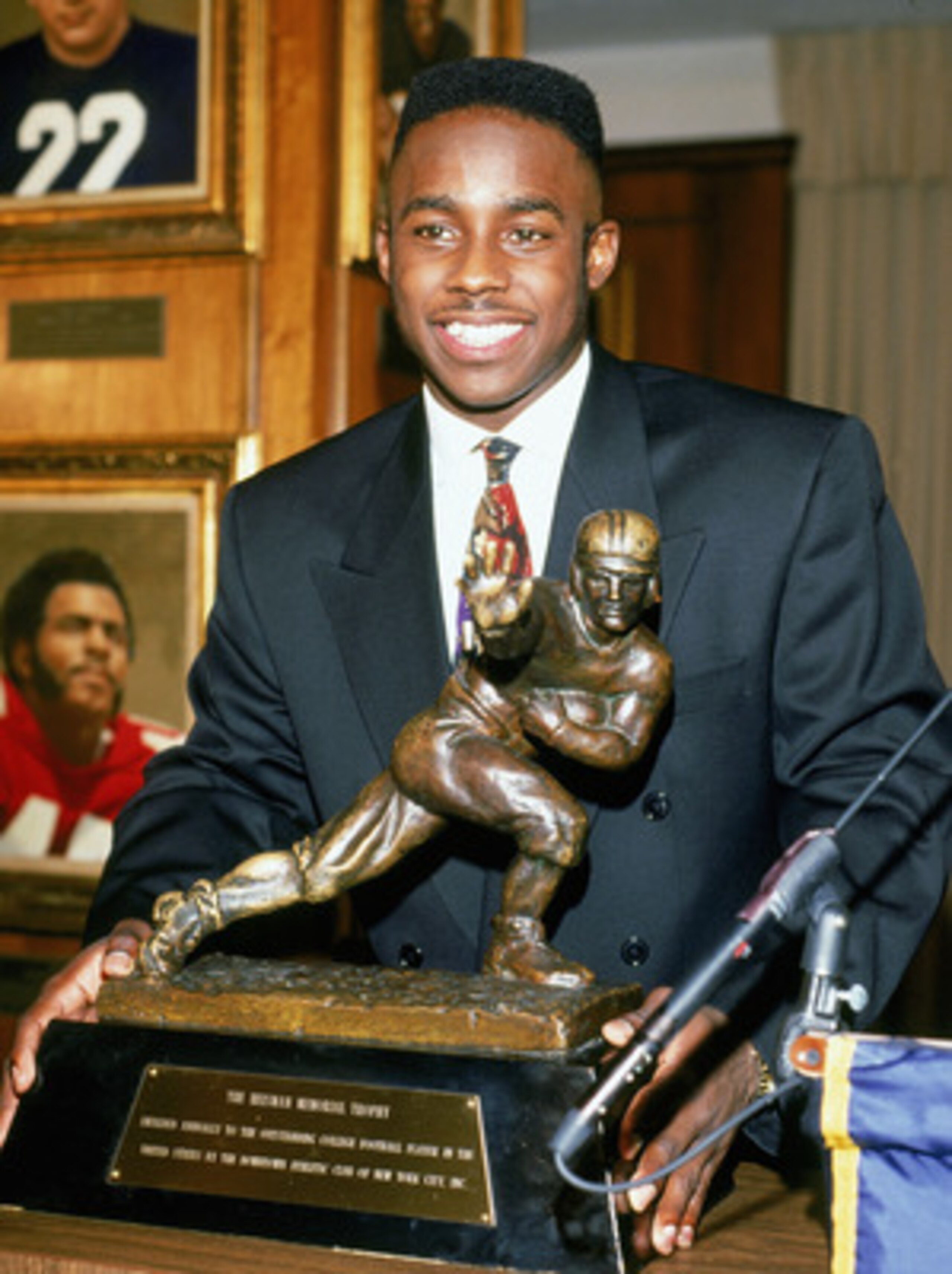 NEW YORK - DECEMBER 14: Desmond Howard #21 of the Michigan Wolverines poses after being awarded the Heisman Trophy given to the top player in the National Collegiate Athletic Association at the Downtown Athletic Club on December 14, 1991 in New York, New NEW YORK - DECEMBER 14: Desmond Howard #21 of the Michigan Wolverines poses after being awarded the Heisman Trophy given to the top player in the National Collegiate Athletic Association at the Downtown Athletic Club on December 14, 1991 in New York, New