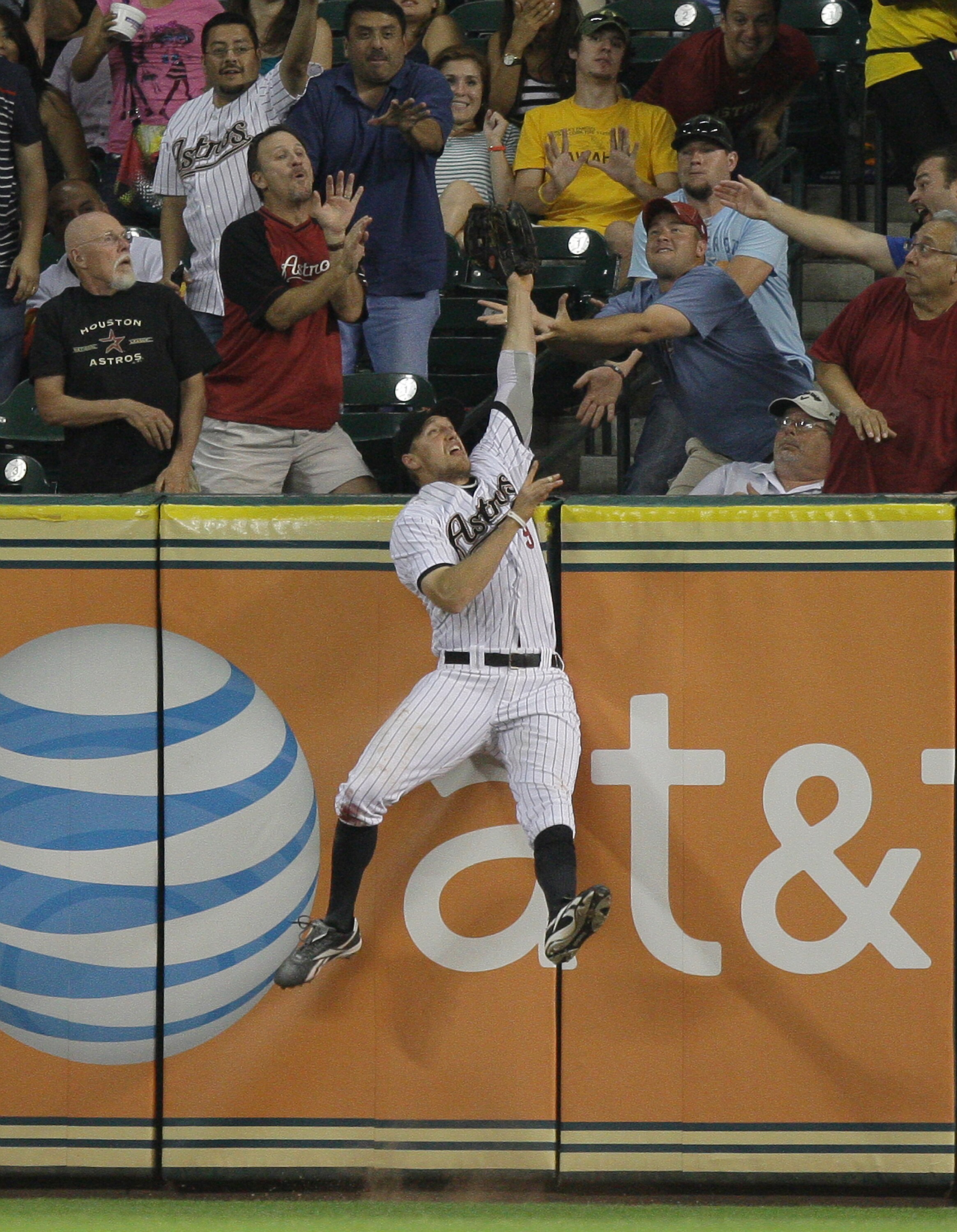 HOUSTON - JUNE 08:  Right fielder Hunter Pence #9 of the Houston Astros leaps but cannot catch a home run hit by Lance Berkman #12 of the St. Louis Cardinals at Minute Maid Park on June 8, 2011 in Houston, Texas. Pitcher Bud Norris #20 of the Houston Astr