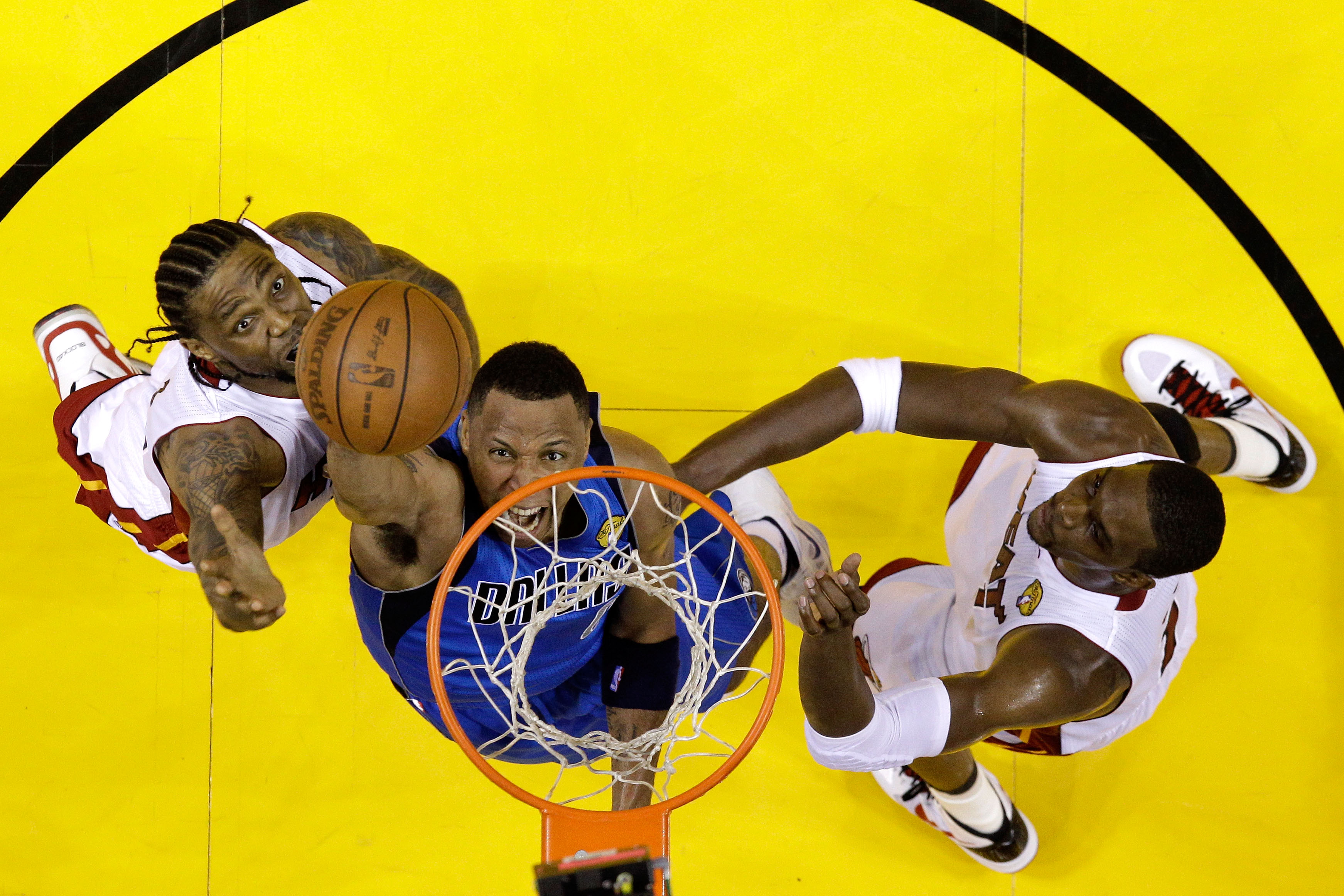 MIAMI, FL - JUNE 12:  Shawn Marion #0 of the Dallas Mavericks attempts a shot against Udonis Haslem #40 and Chris Bosh #1 of the Miami Heat in Game Six of the 2011 NBA Finals at American Airlines Arena on June 12, 2011 in Miami, Florida. NOTE TO USER: Use