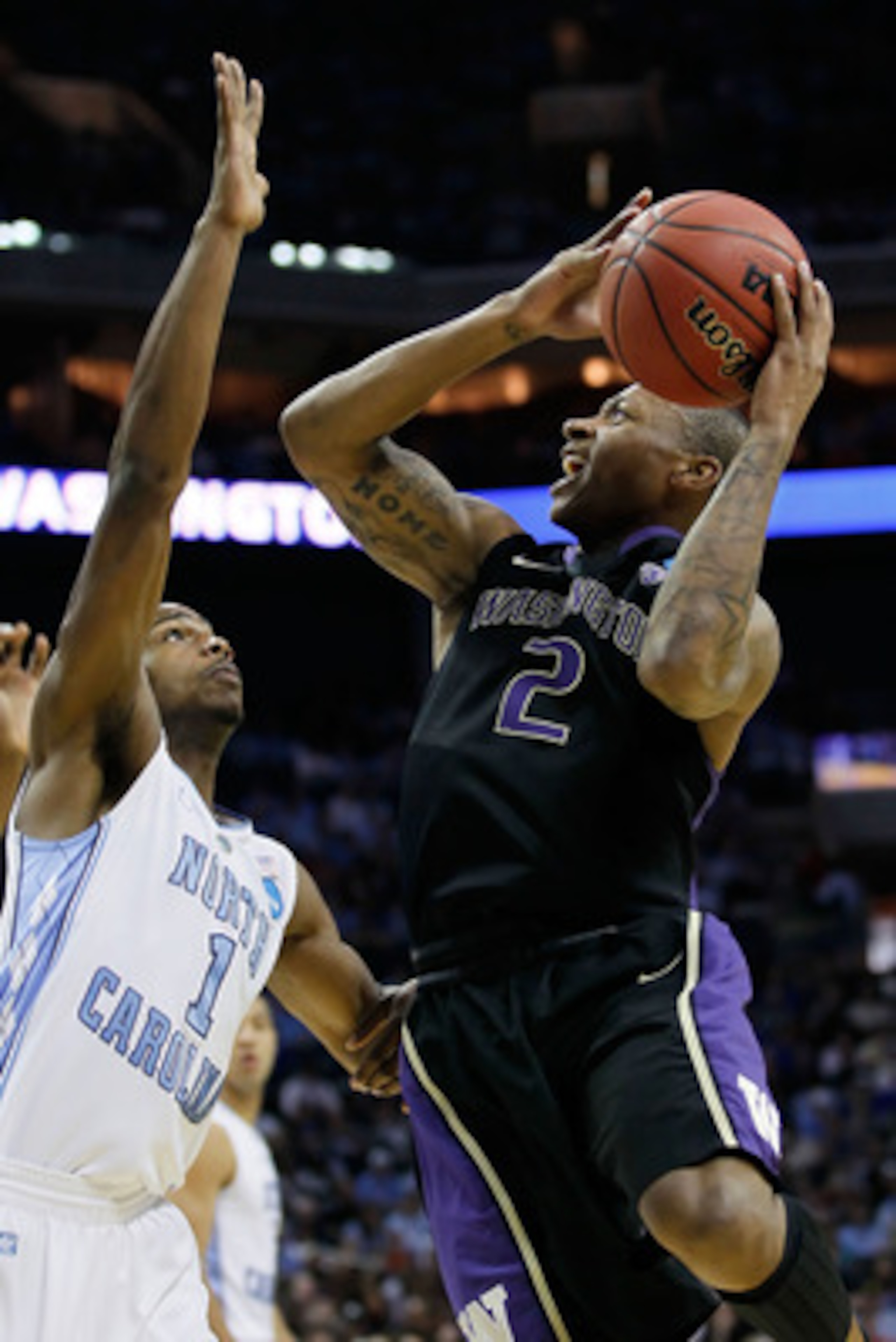 CHARLOTTE, NC - MARCH 20:  Isaiah Thomas #2 of the Washington Huskies shoots over Dexter Strickland #1 of the North Carolina Tar Heels in the first half during the third round of the 2011 NCAA men's basketball tournament at Time Warner Cable Arena on Marc